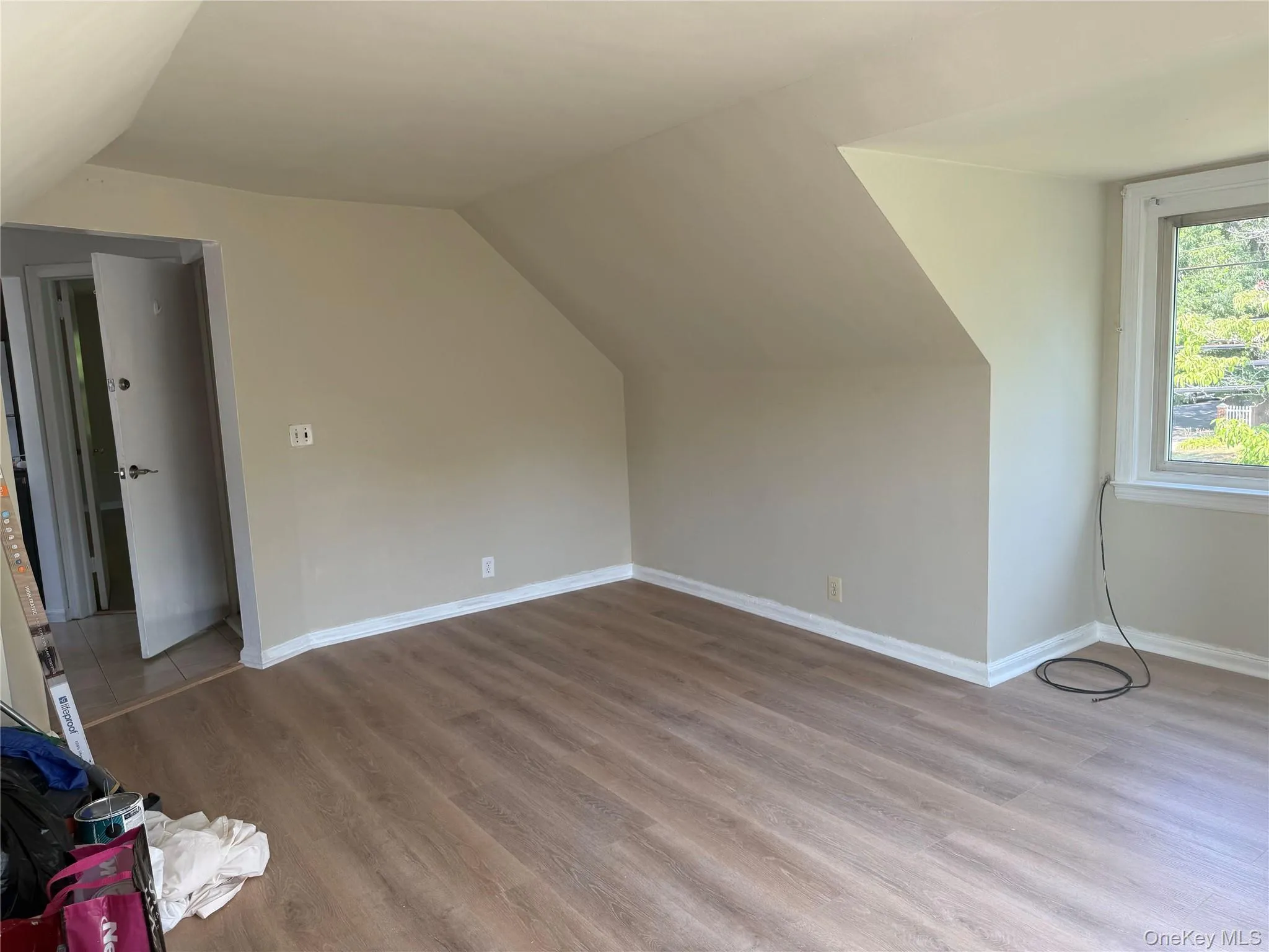 Additional living space with wood finished floors and vaulted ceiling Additional living space with wood finished floors and vaulted ceiling