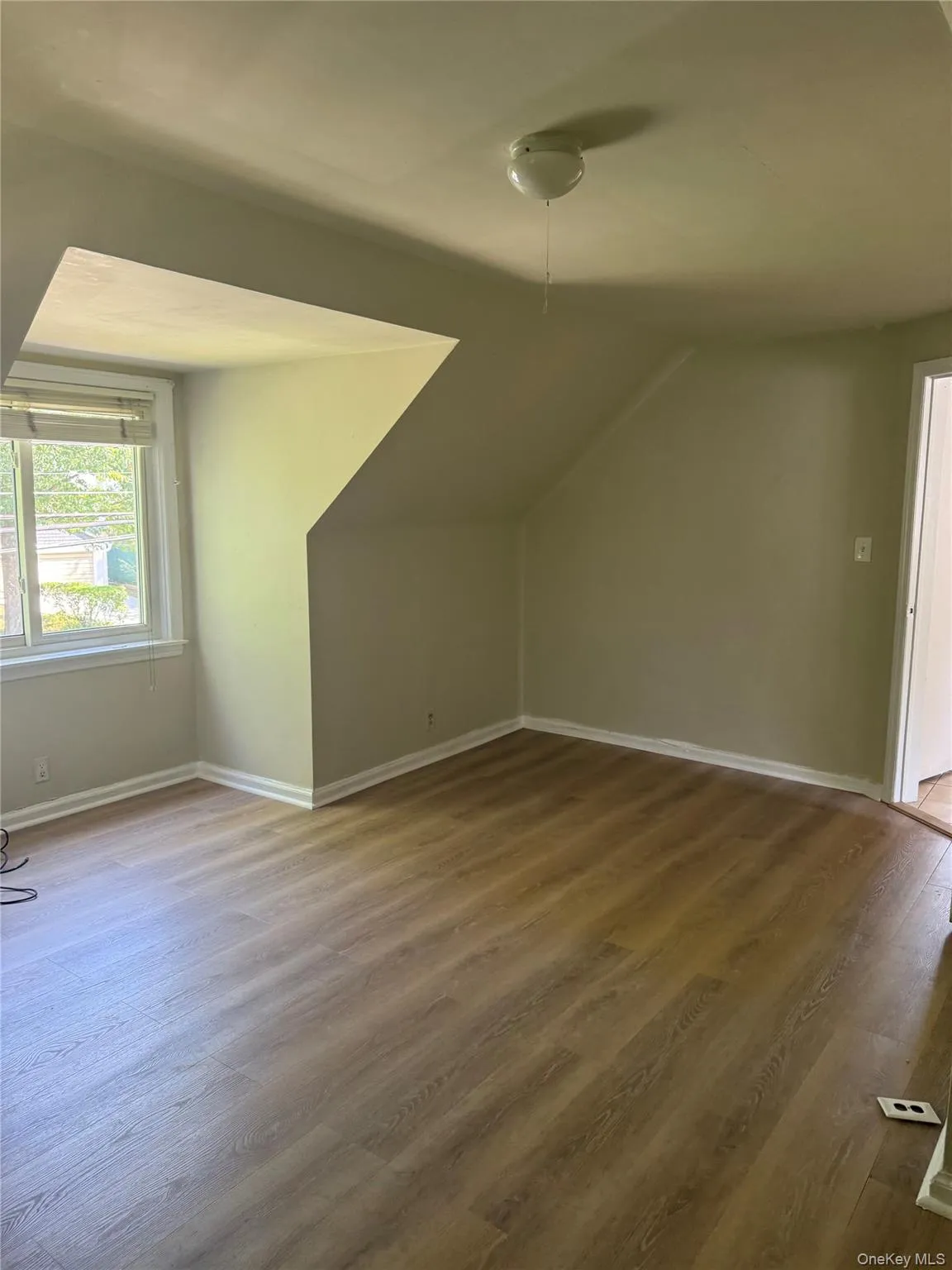Additional living space featuring wood finished floors and lofted ceiling Additional living space featuring wood finished floors and lofted ceiling