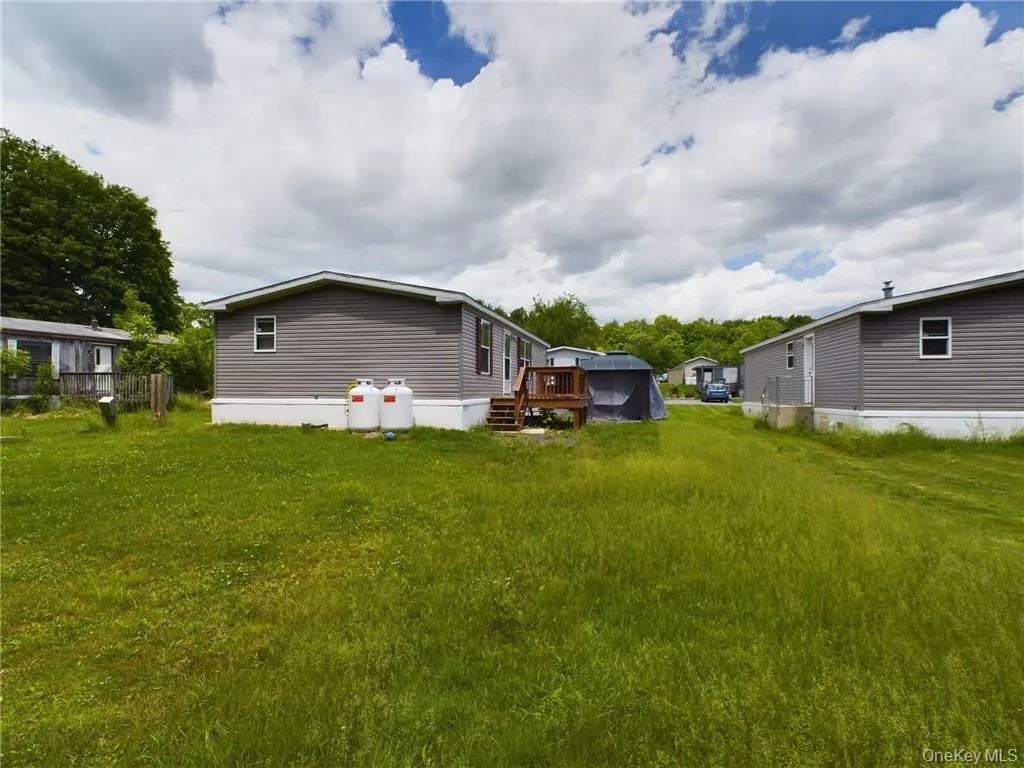 View of yard with a wooden deck View of yard with a wooden deck