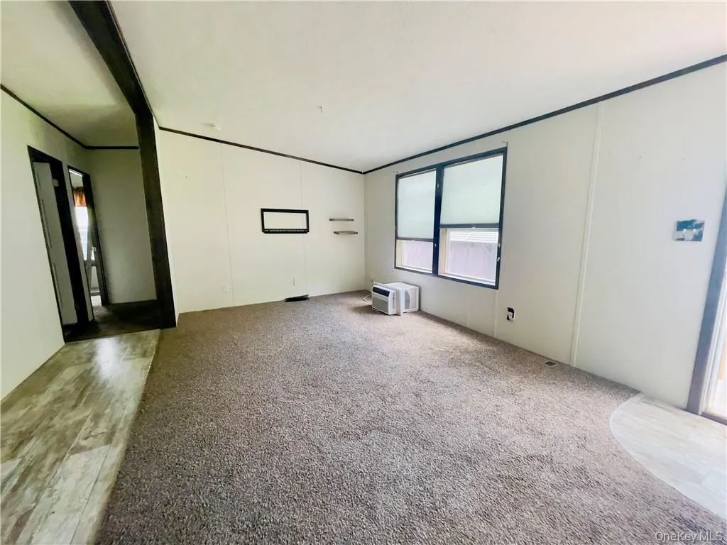 Unfurnished room with hardwood / wood-style floors Unfurnished room with hardwood / wood-style floors