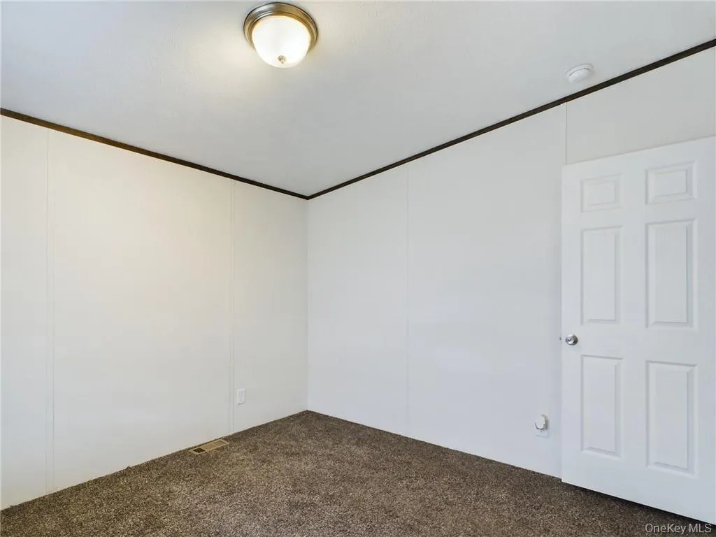 View of carpeted empty room View of carpeted empty room