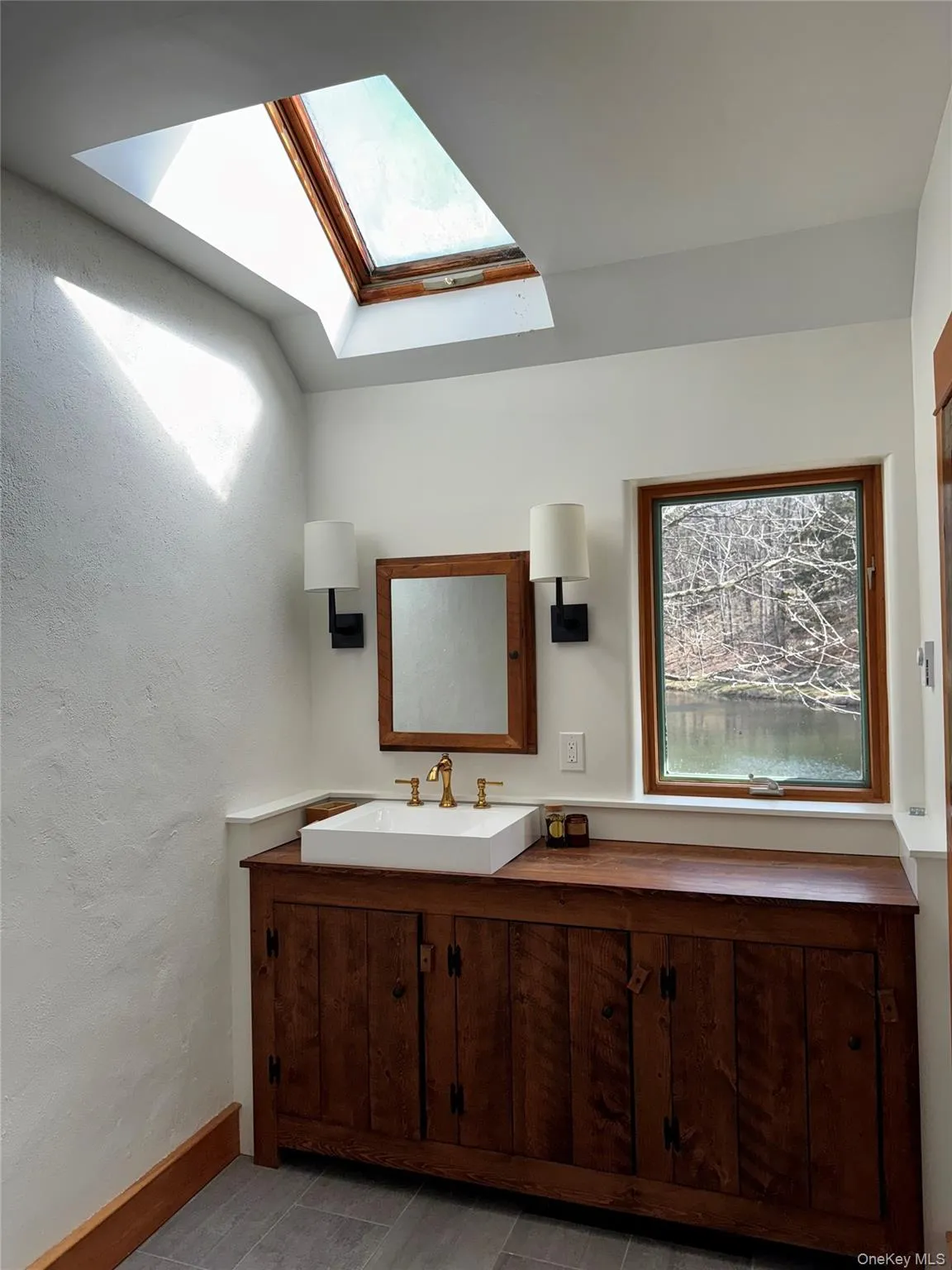 Primary Bath with Vaulted Ceiling, Skylight & Pond Views Primary Bath with Vaulted Ceiling, Skylight & Pond Views