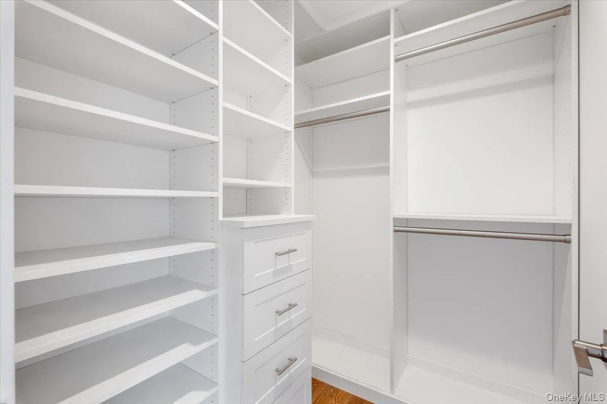 Primary walk-in outfitted closet Primary walk-in outfitted closet