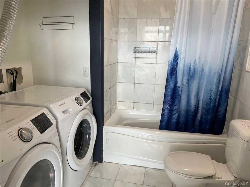 Bathroom with washer and dryer Bathroom with washer and dryer