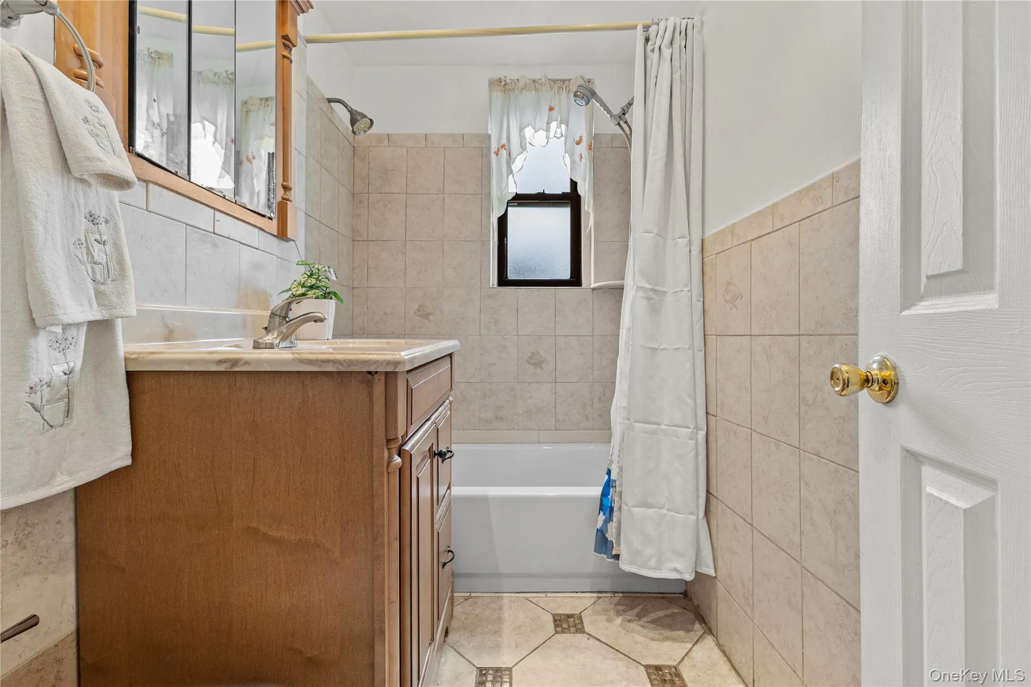 The full bathroom was renovated with dual shower heads, tile all around, and a large vanity and medicine cabinet for lots of storage. The full bathroom was renovated with dual shower heads, tile all around, and a large vanity and medicine cabinet for lots of storage.