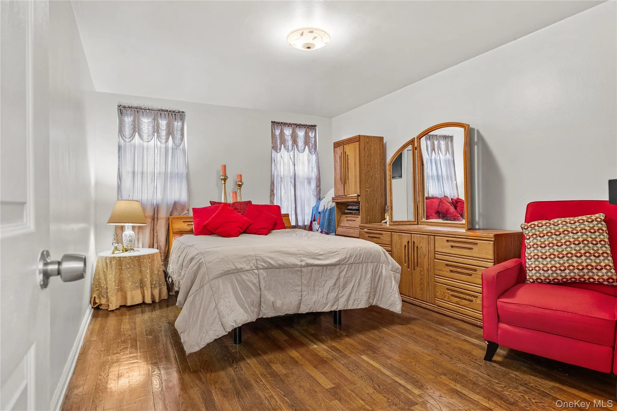 The roomy primary bedroom has the same hardwood floors that are throughout the unit and . . . The roomy primary bedroom has the same hardwood floors that are throughout the unit and . . .