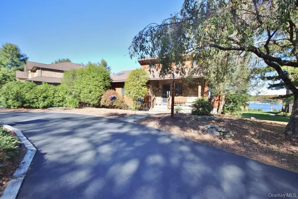 Obstructed view of property with stone siding Obstructed view of property with stone siding