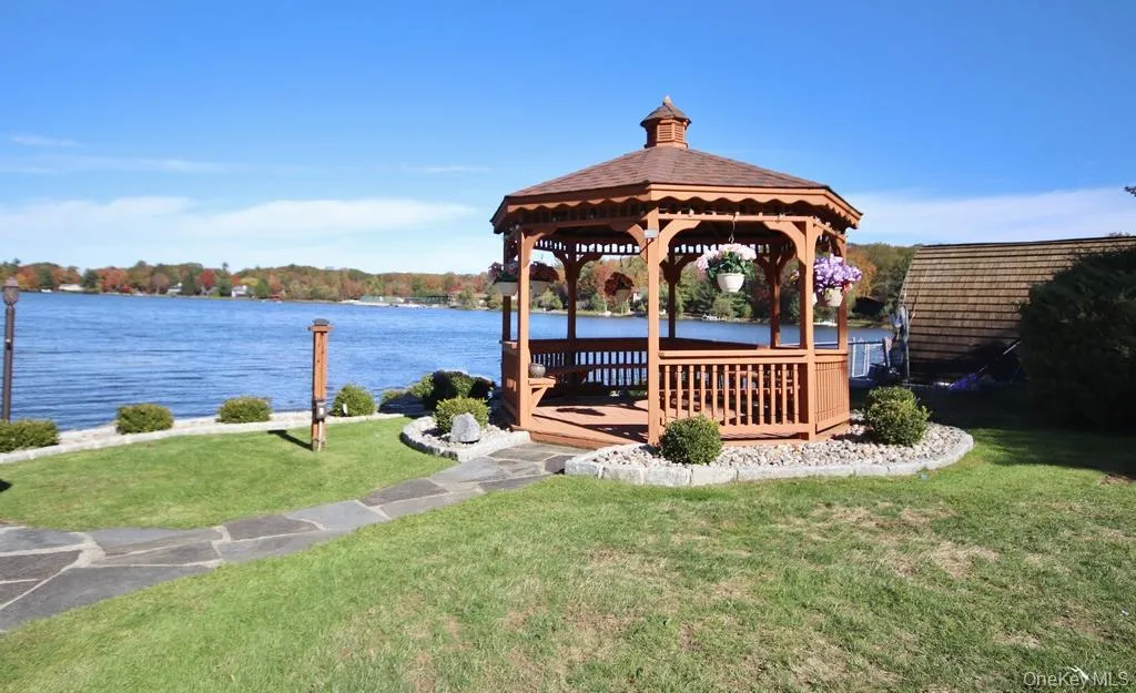 Dock with a gazebo, a lawn, and a deck with water view Dock with a gazebo, a lawn, and a deck with water view