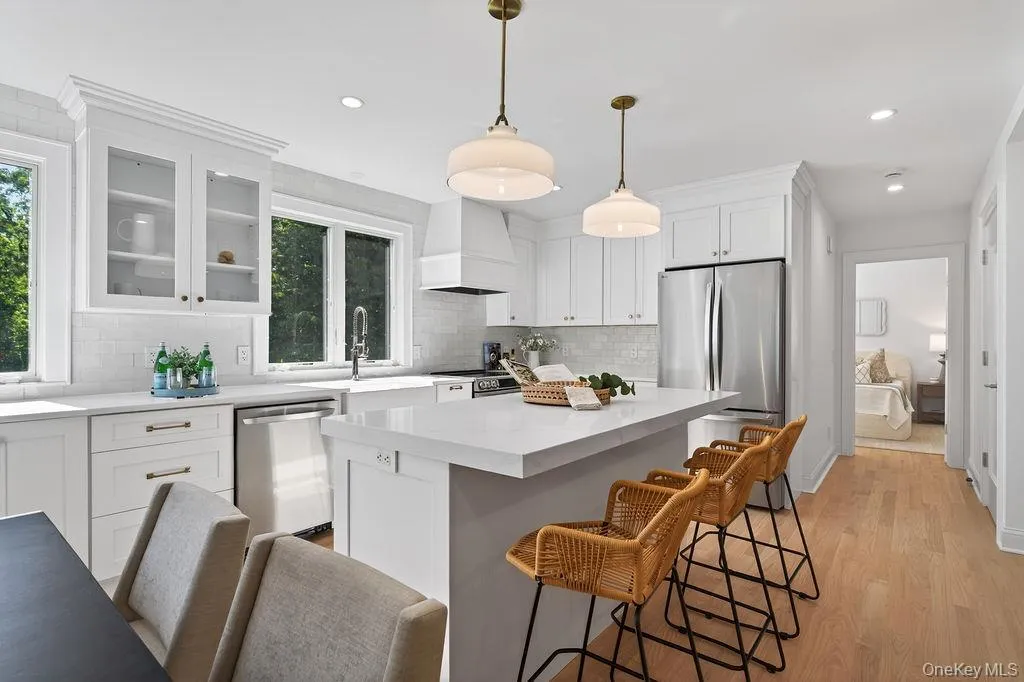 Quartz countertops, stainless steel appliances. Hallway to first floor bedroom suite. Quartz countertops, stainless steel appliances. Hallway to first floor bedroom suite.