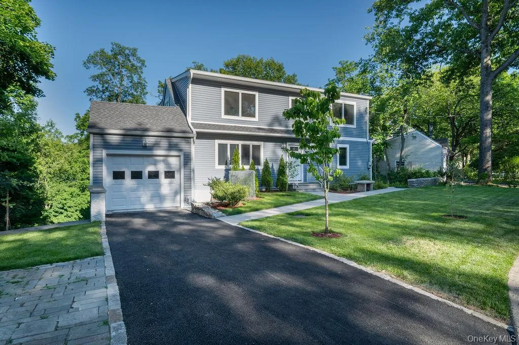 Expanded Cape Cod with one car garage with new driveway. Expanded Cape Cod with one car garage with new driveway.