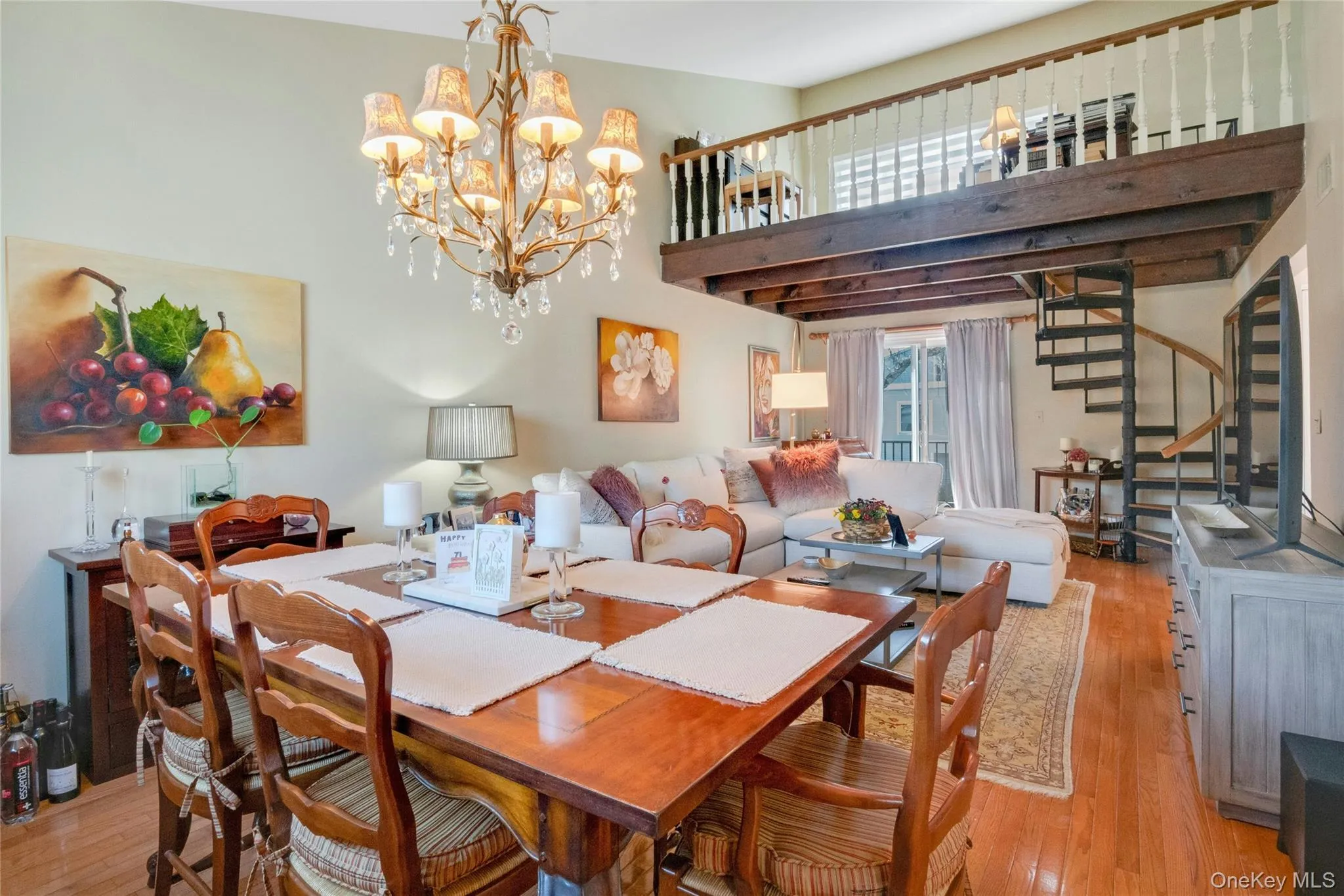 Open-concept living space with wood-finish flooring Open-concept living space with wood-finish flooring