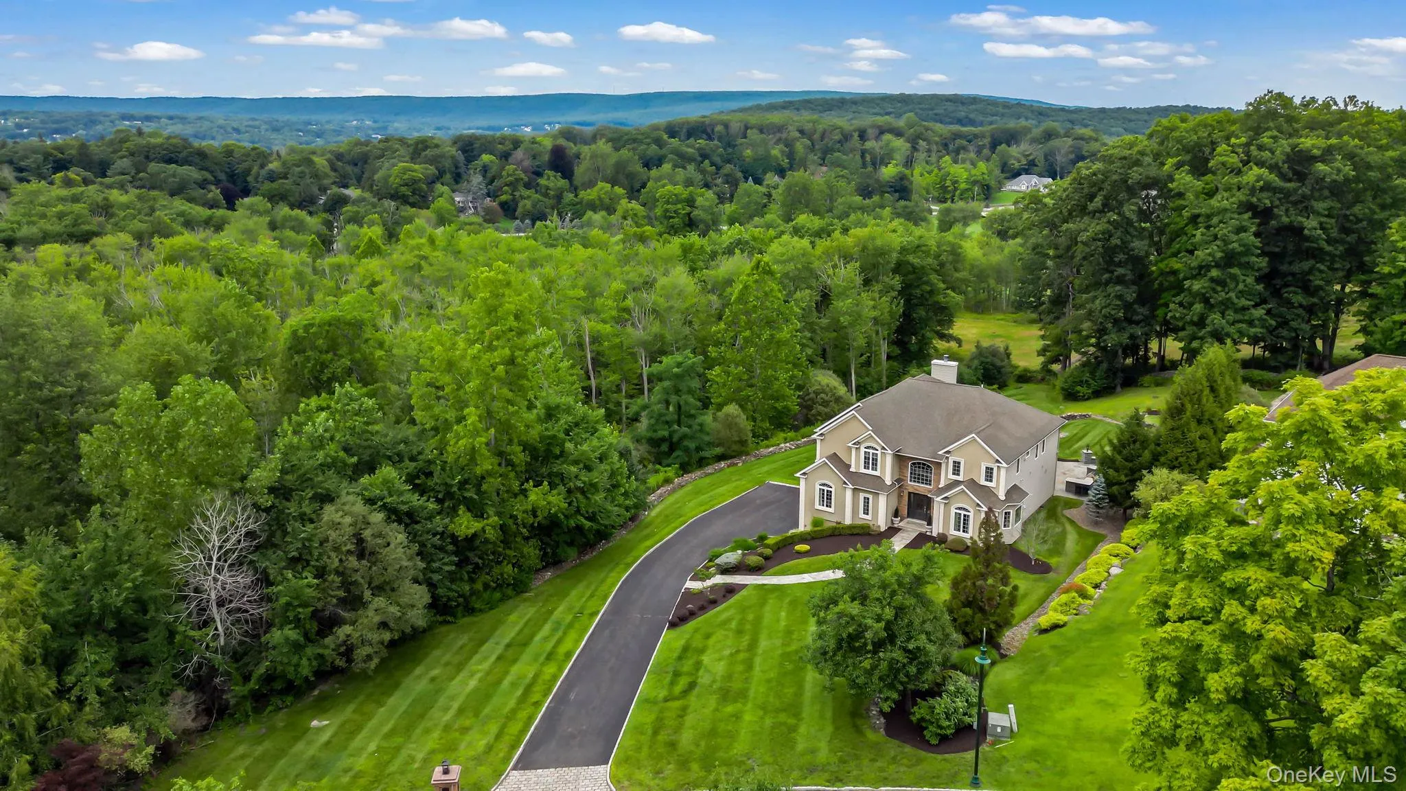 Aerial view of home with lush landscaping privacy and mountains in the backdrop Aerial view of home with lush landscaping privacy and mountains in the backdrop