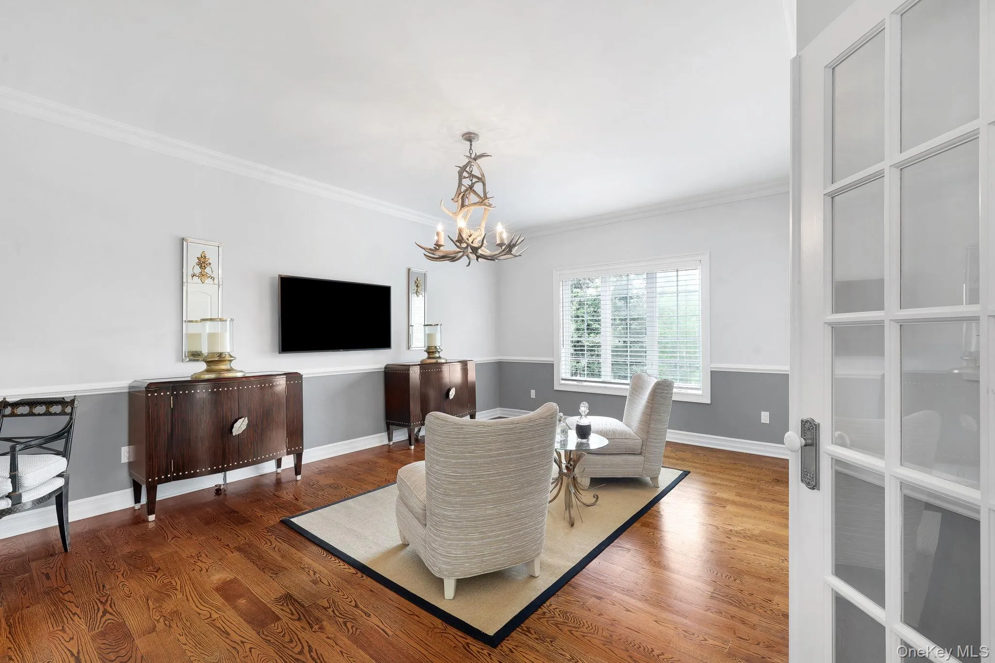 Hardwood flooring, crown molding, double doors and custom decorative antler chandelier Hardwood flooring, crown molding, double doors and custom decorative antler chandelier