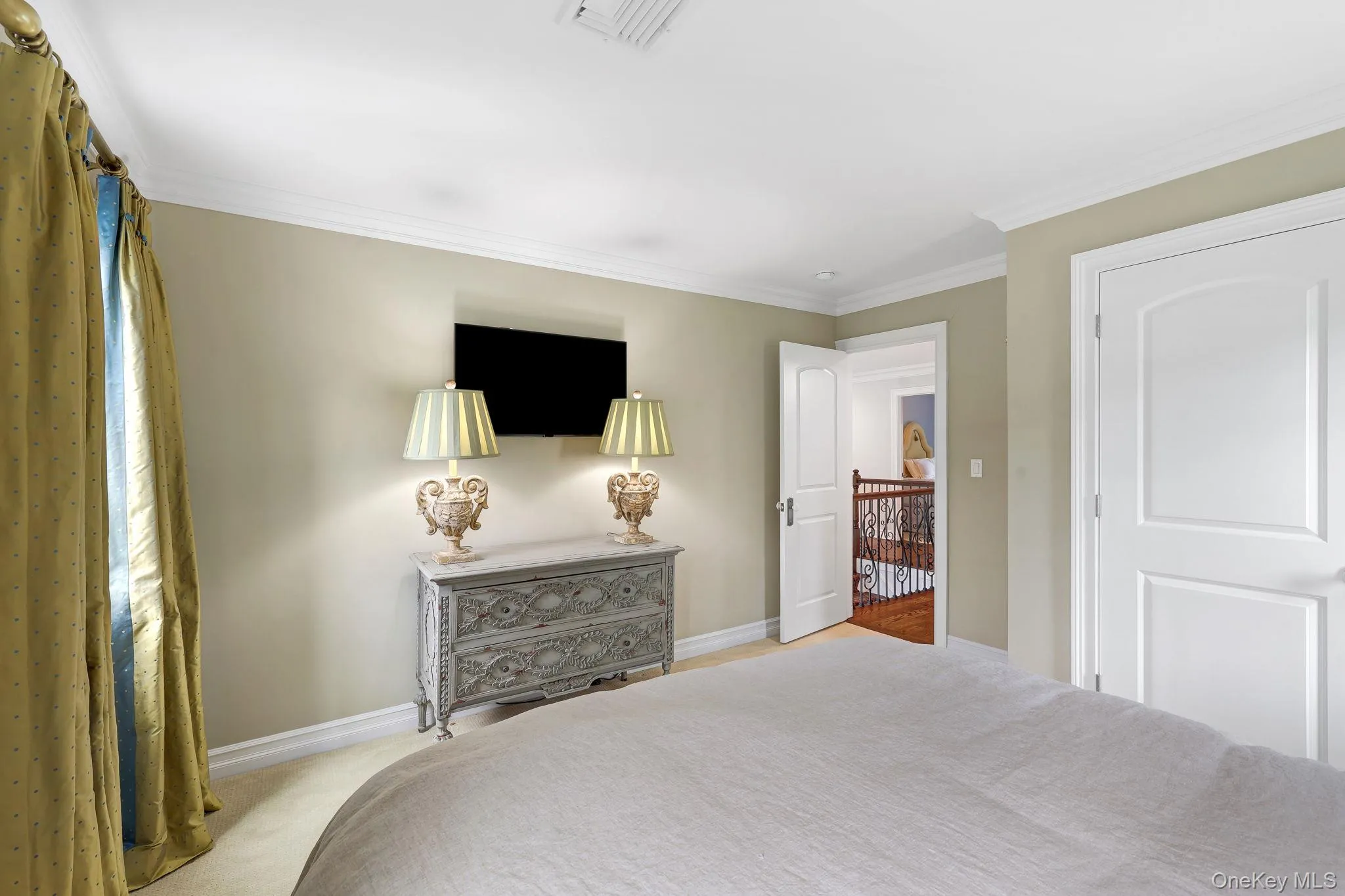 Crown molding and neutral wall tones create a refined aesthetic Crown molding and neutral wall tones create a refined aesthetic
