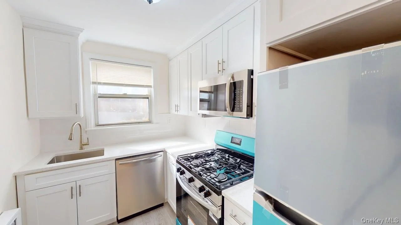 The kitchen features white cabinetry, stainless steel appliances, and a window above the sink. Was renovated March 2026 The kitchen features white cabinetry, stainless steel appliances, and a window above the sink. Was renovated March 2026