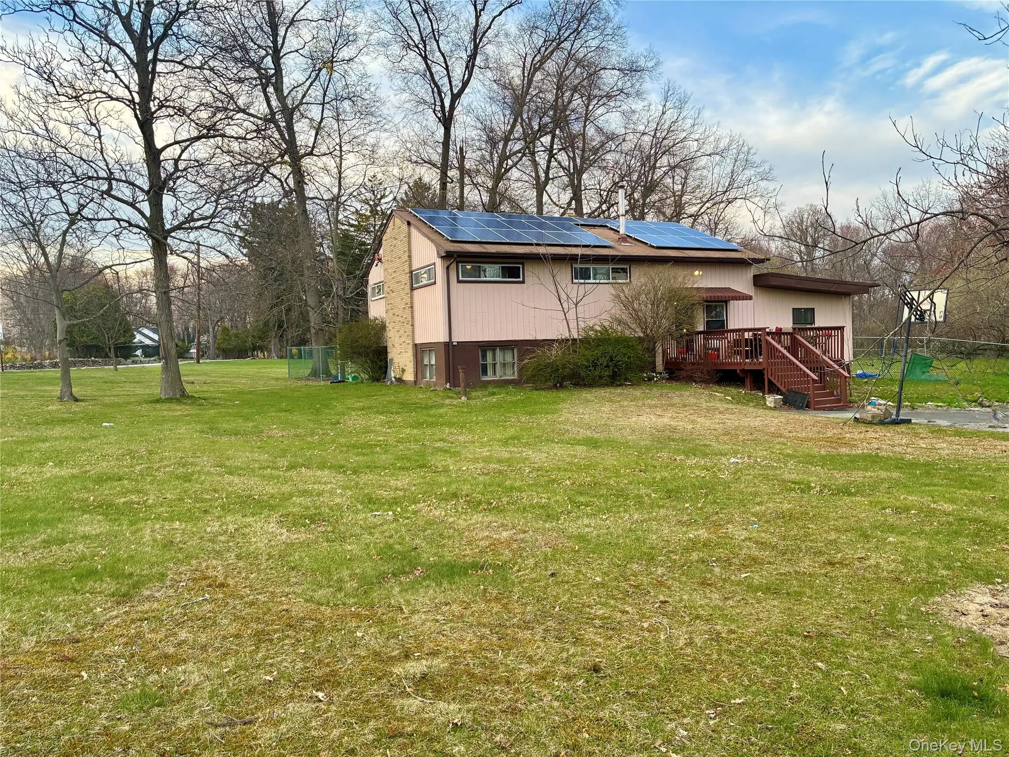 Back deck off of kitchen and expansive yard Back deck off of kitchen and expansive yard