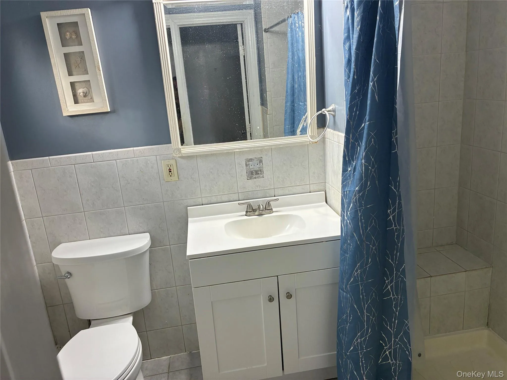 Full bath with shower next to entry hall Full bath with shower next to entry hall
