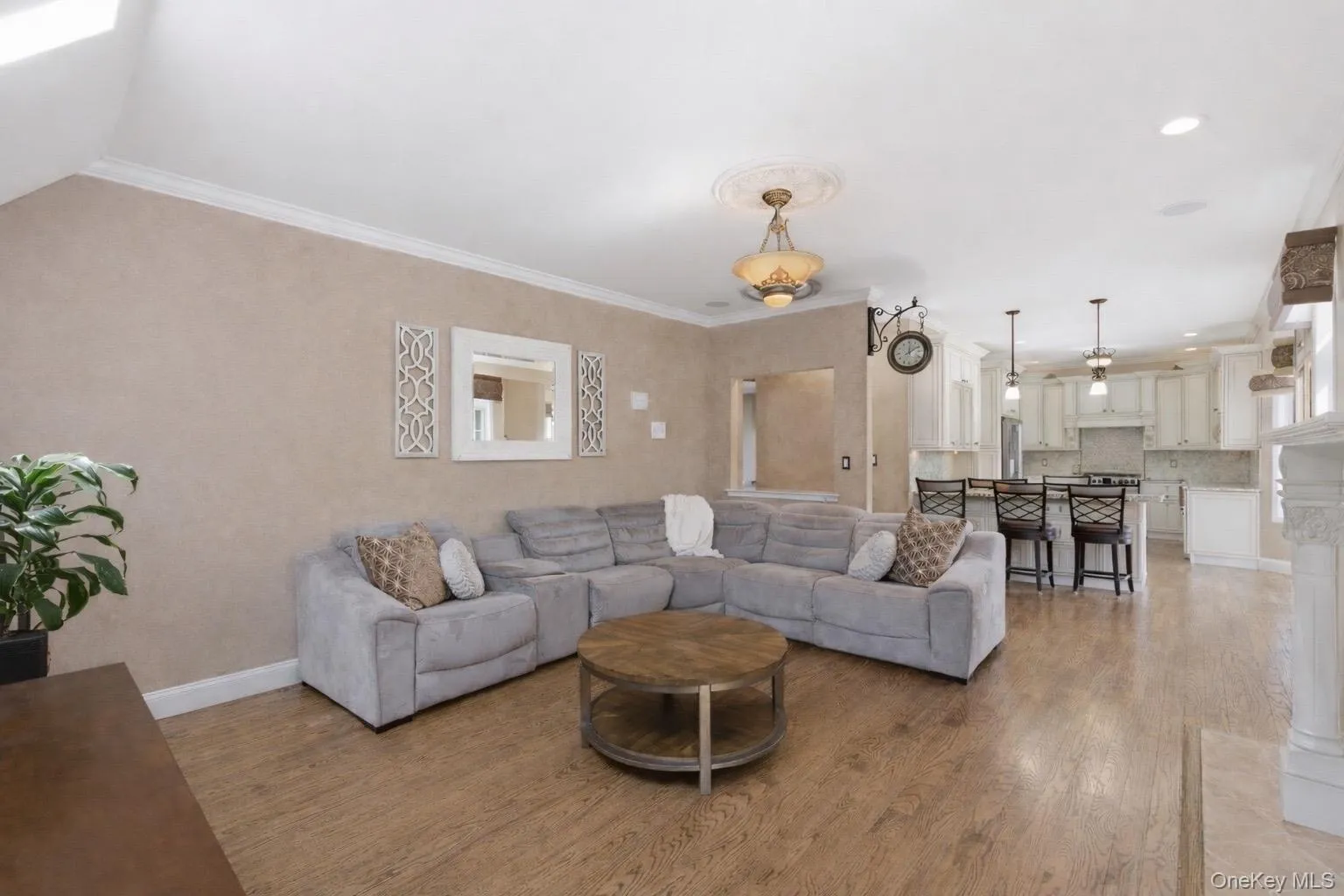 Living area with hardwood flooring, crown molding, and a decorative ceiling medallion Living area with hardwood flooring, crown molding, and a decorative ceiling medallion