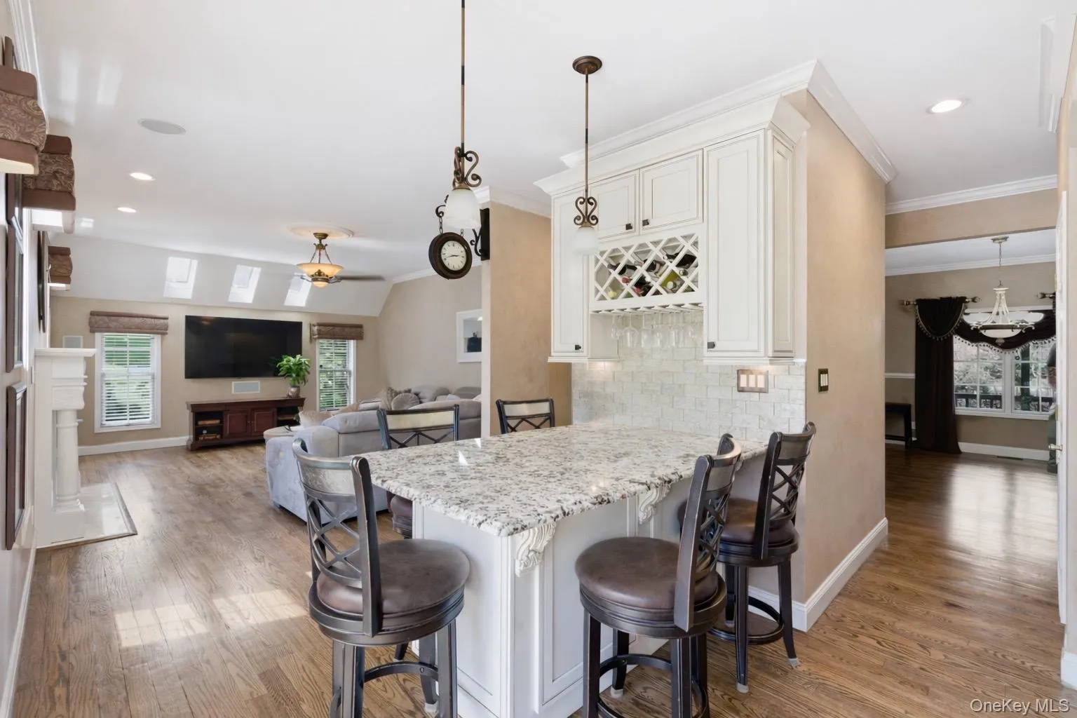 This property features an open living area with hardwood flooring, a vaulted ceiling, and skylights providing natural light This property features an open living area with hardwood flooring, a vaulted ceiling, and skylights providing natural light