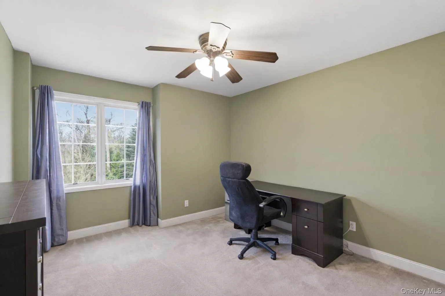 This room features a window with white sashes, light green walls, and light-colored carpeting This room features a window with white sashes, light green walls, and light-colored carpeting