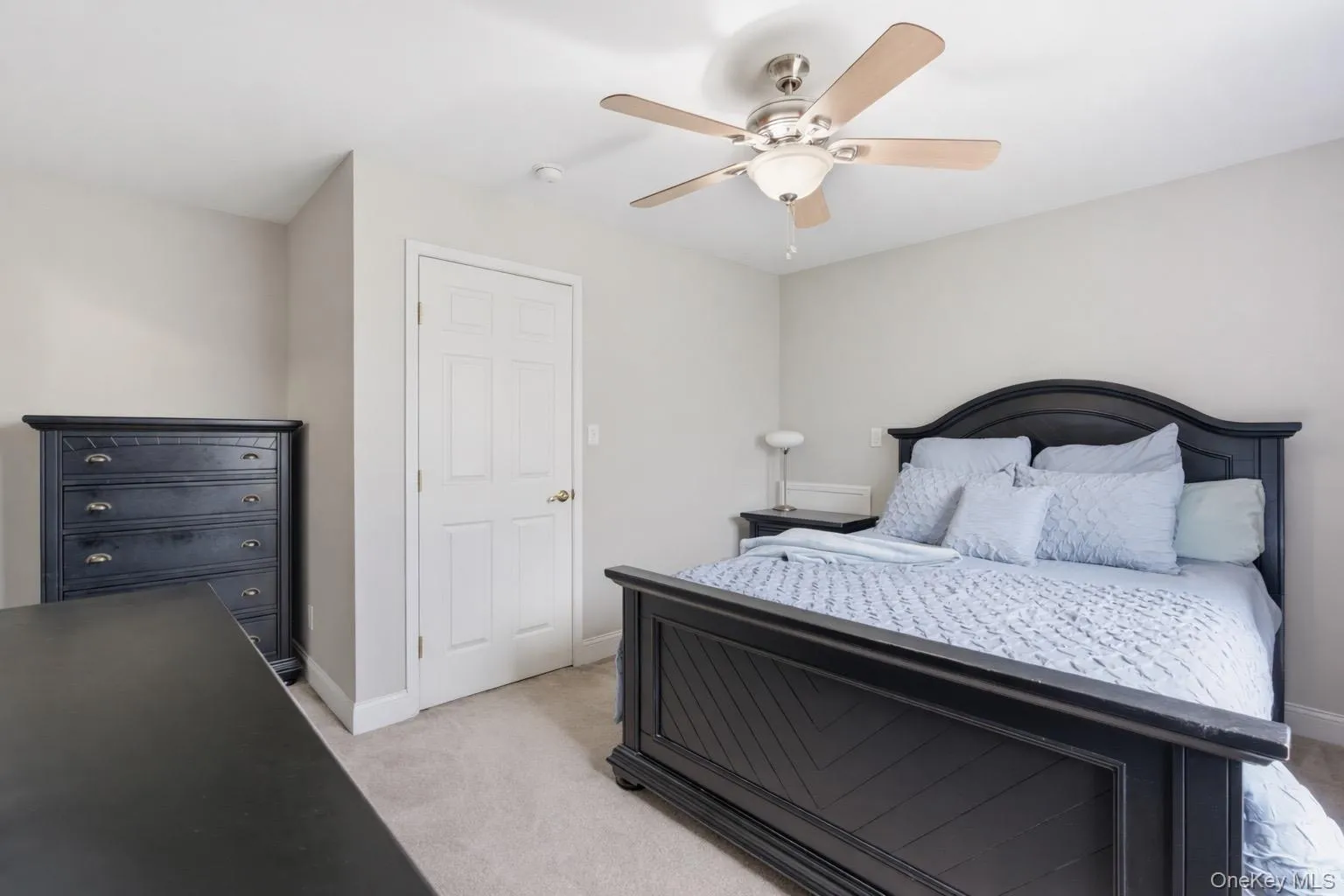 This room features neutral-toned carpet, light gray walls, and a ceiling fan with integrated lighting This room features neutral-toned carpet, light gray walls, and a ceiling fan with integrated lighting