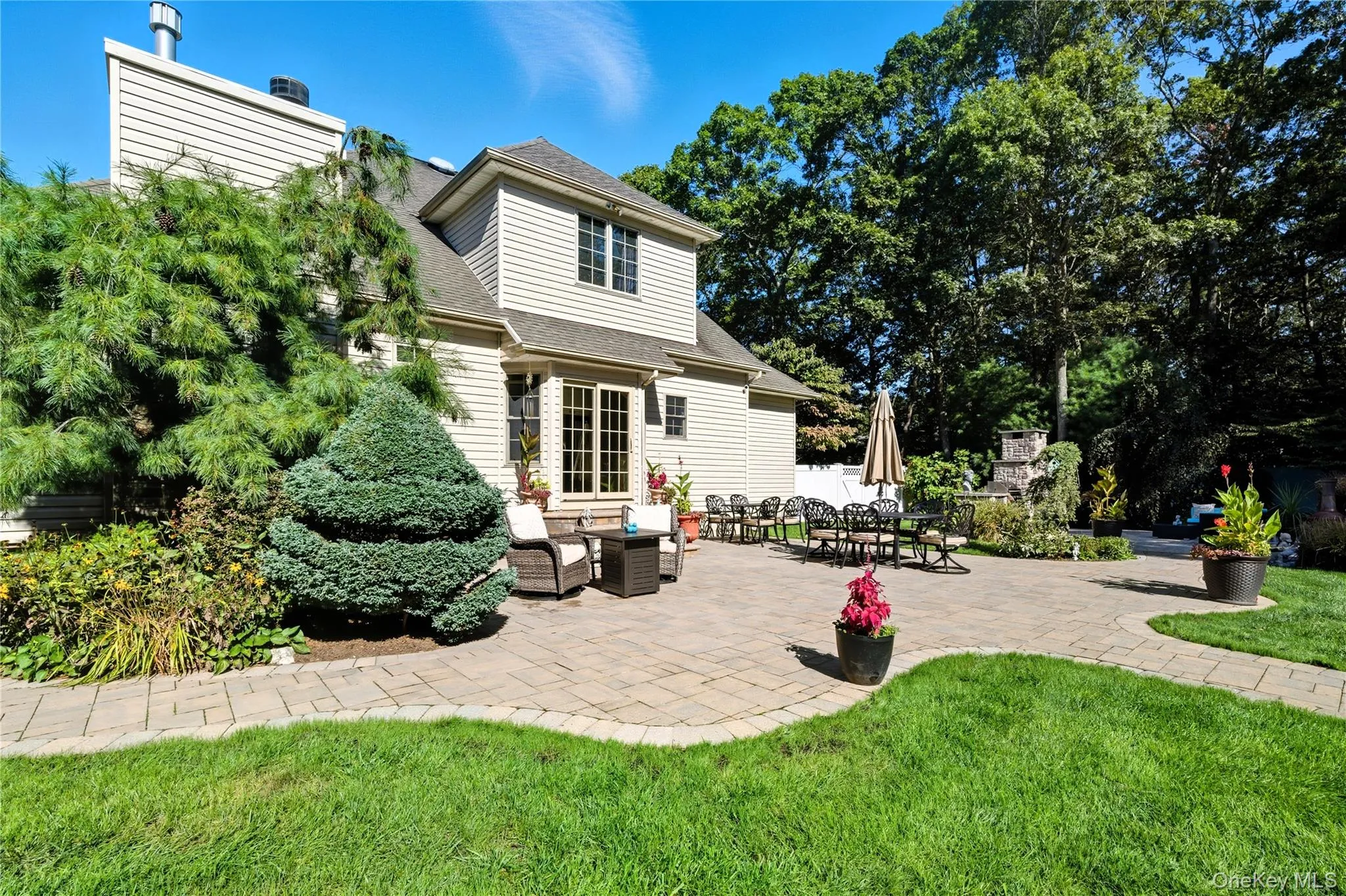 Rear view of house with a patio area, a yard, an outdoor living space with a fireplace. Rear view of house with a patio area, a yard, an outdoor living space with a fireplace.