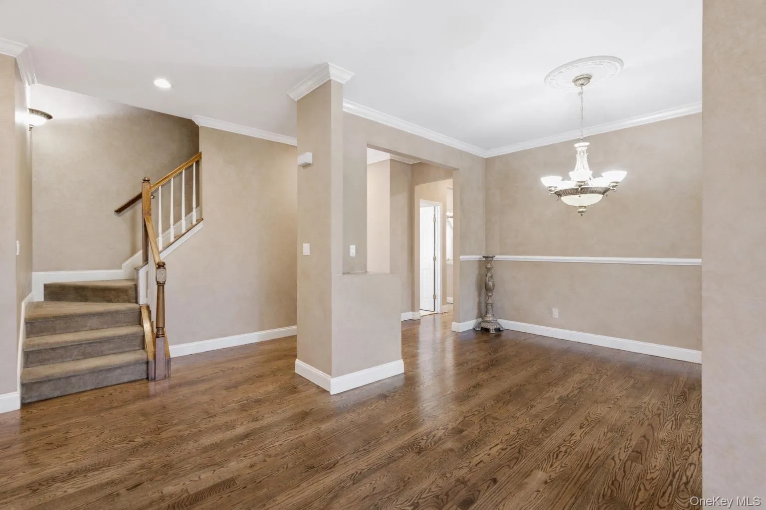 This property offers impressive hardwood flooring and a carpeted staircase with a wooden banister This property offers impressive hardwood flooring and a carpeted staircase with a wooden banister