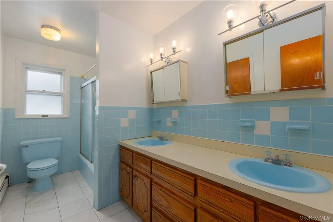Upstairs hall full bath with double sinks. Upstairs hall full bath with double sinks.