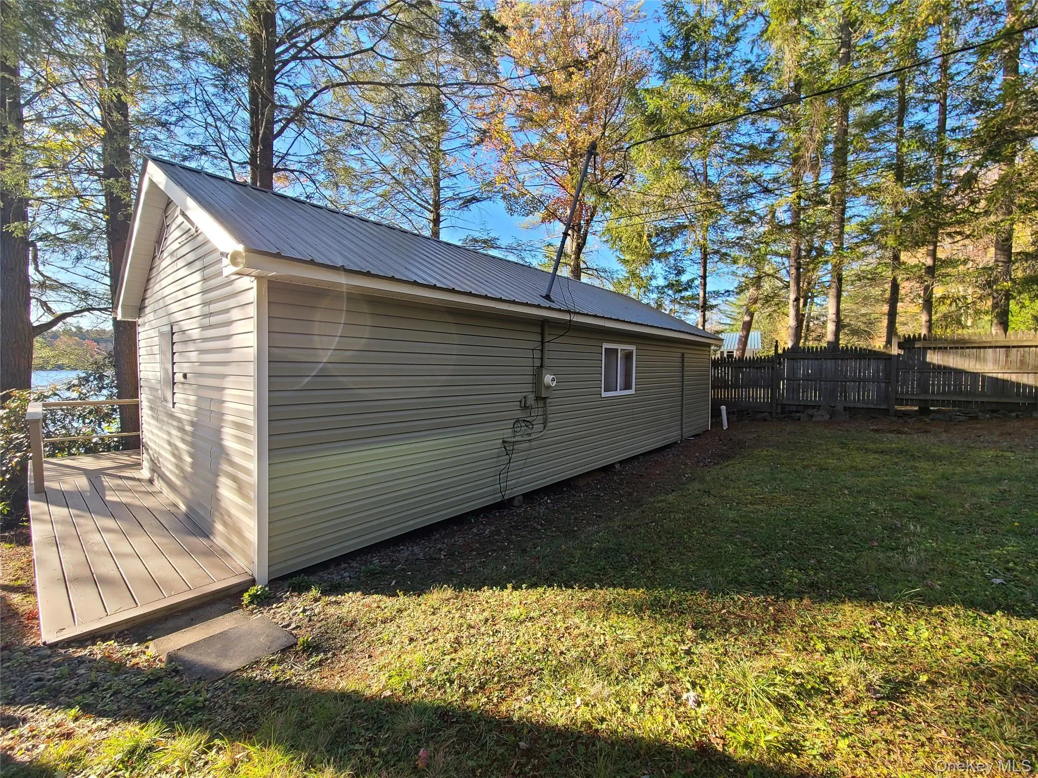 View of home's exterior featuring a metal roof and a deck View of home's exterior featuring a metal roof and a deck