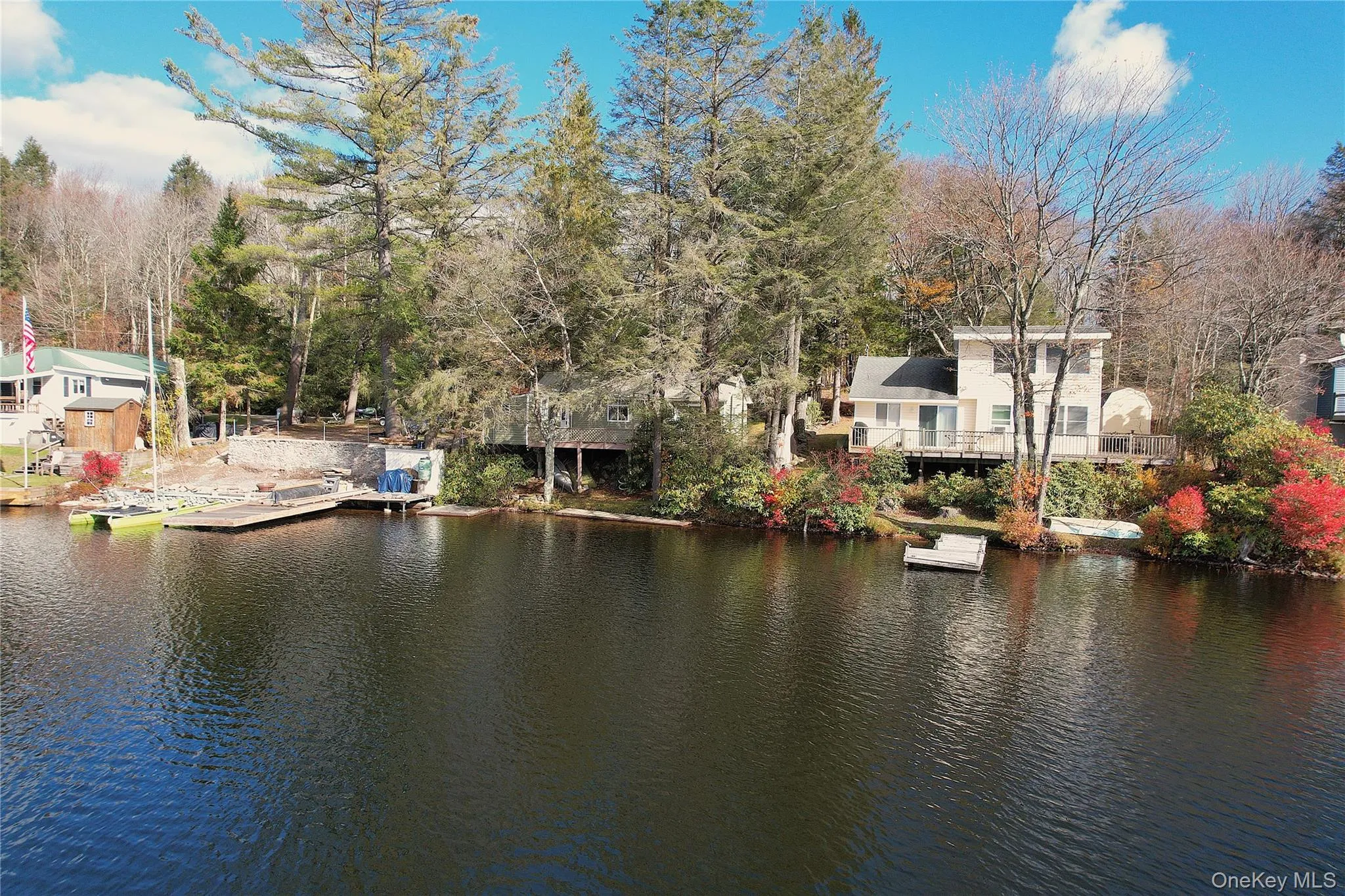 Water view featuring a floating dock and a tree filled landscape Water view featuring a floating dock and a tree filled landscape