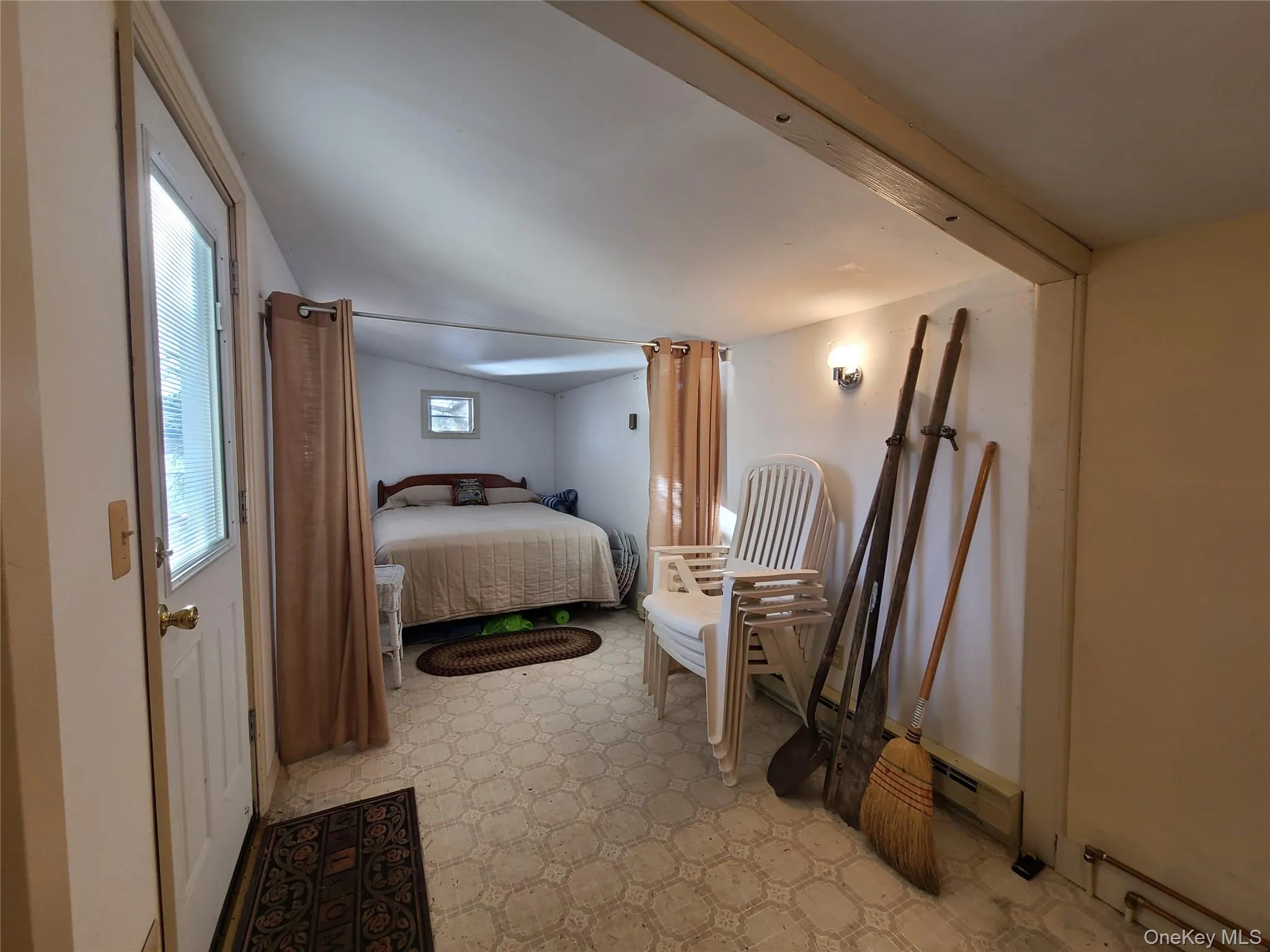 Bedroom featuring light floors and a baseboard radiator Bedroom featuring light floors and a baseboard radiator