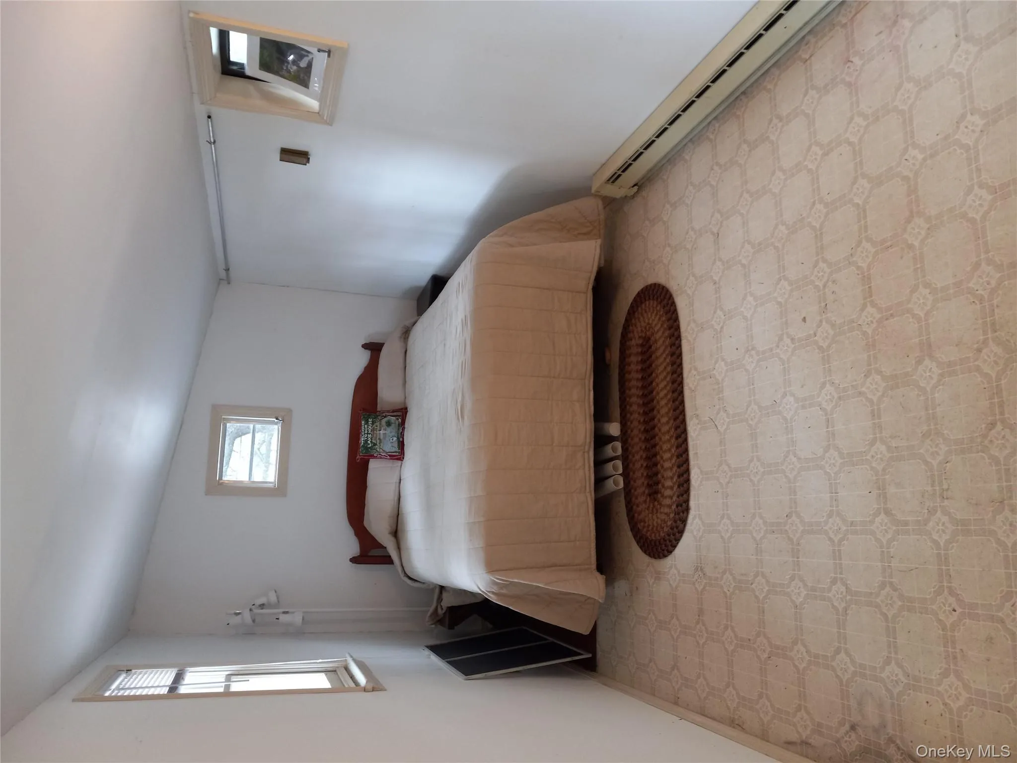 Bedroom with a baseboard radiator and light flooring Bedroom with a baseboard radiator and light flooring