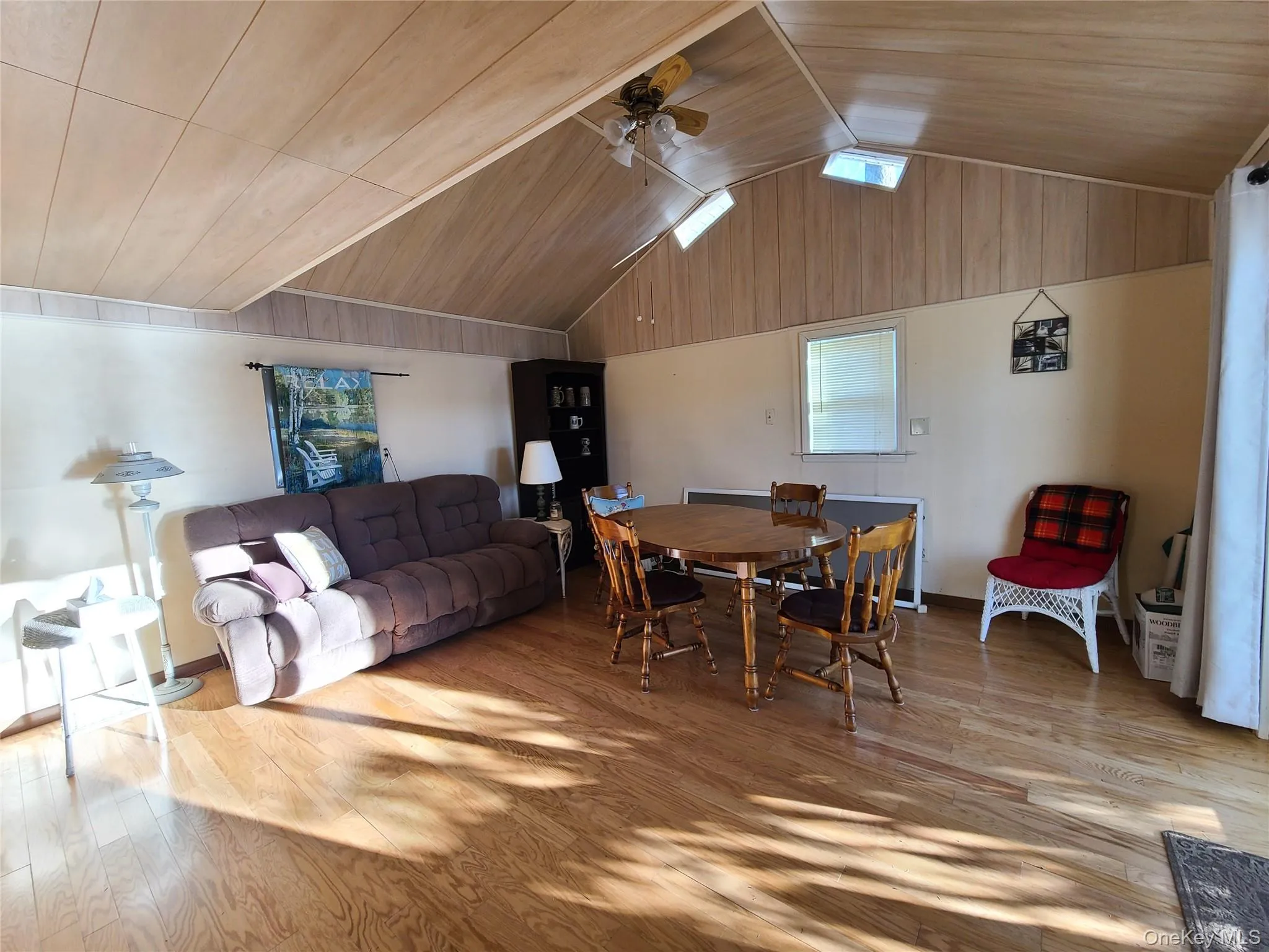 Dining room featuring light wood-type flooring, vaulted ceiling, a ceiling fan, and wooden ceiling Dining room featuring light wood-type flooring, vaulted ceiling, a ceiling fan, and wooden ceiling