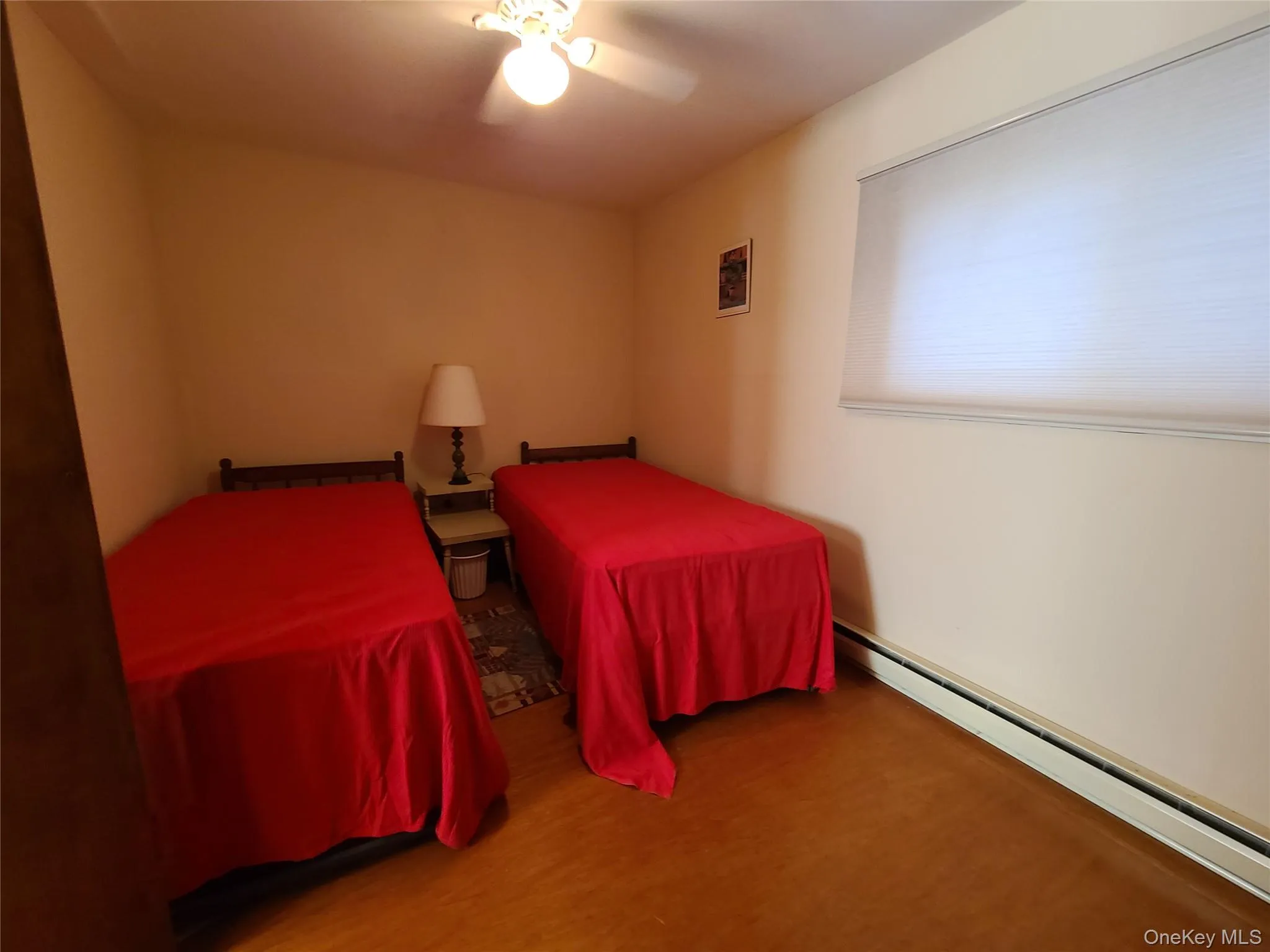 Bedroom with a baseboard heating unit and ceiling fan Bedroom with a baseboard heating unit and ceiling fan