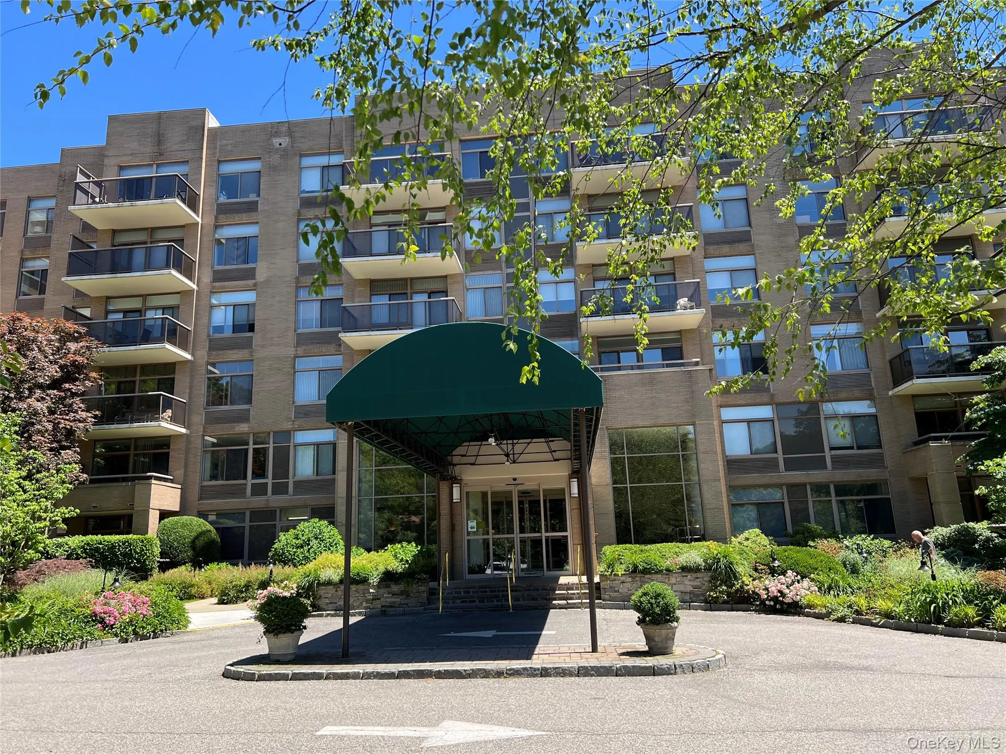 35 North Chatsworth Avenue 1J. Multi-story building featuring a brick exterior and a covered entryway 35 North Chatsworth Avenue 1J. Multi-story building featuring a brick exterior and a covered entryway