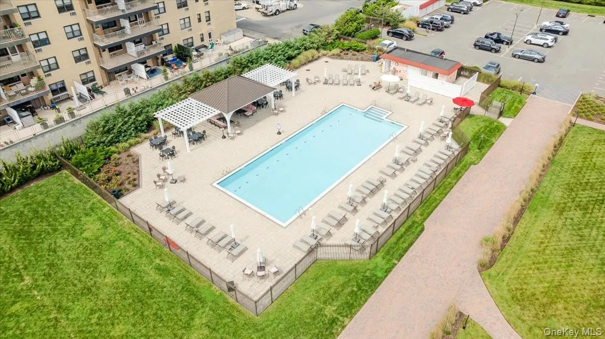 Bird's eye view of a pool area and apartment complex / building Bird's eye view of a pool area and apartment complex / building
