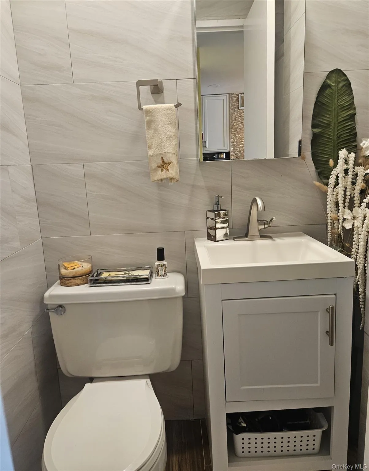 Half bathroom with tile walls, vanity, and backsplash Half bathroom with tile walls, vanity, and backsplash