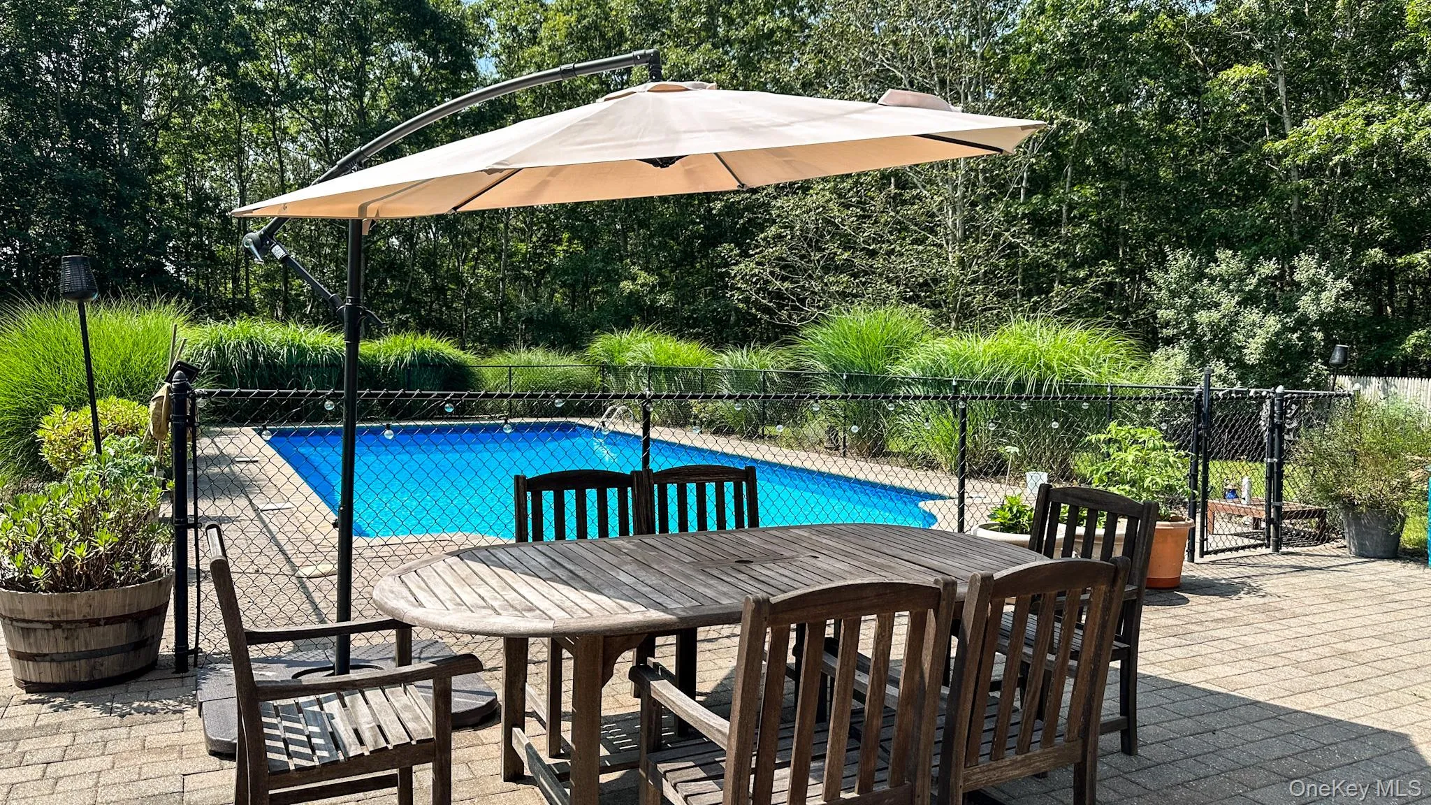 View of pool with outdoor dining space, fence, a fenced in pool, and a patio View of pool with outdoor dining space, fence, a fenced in pool, and a patio