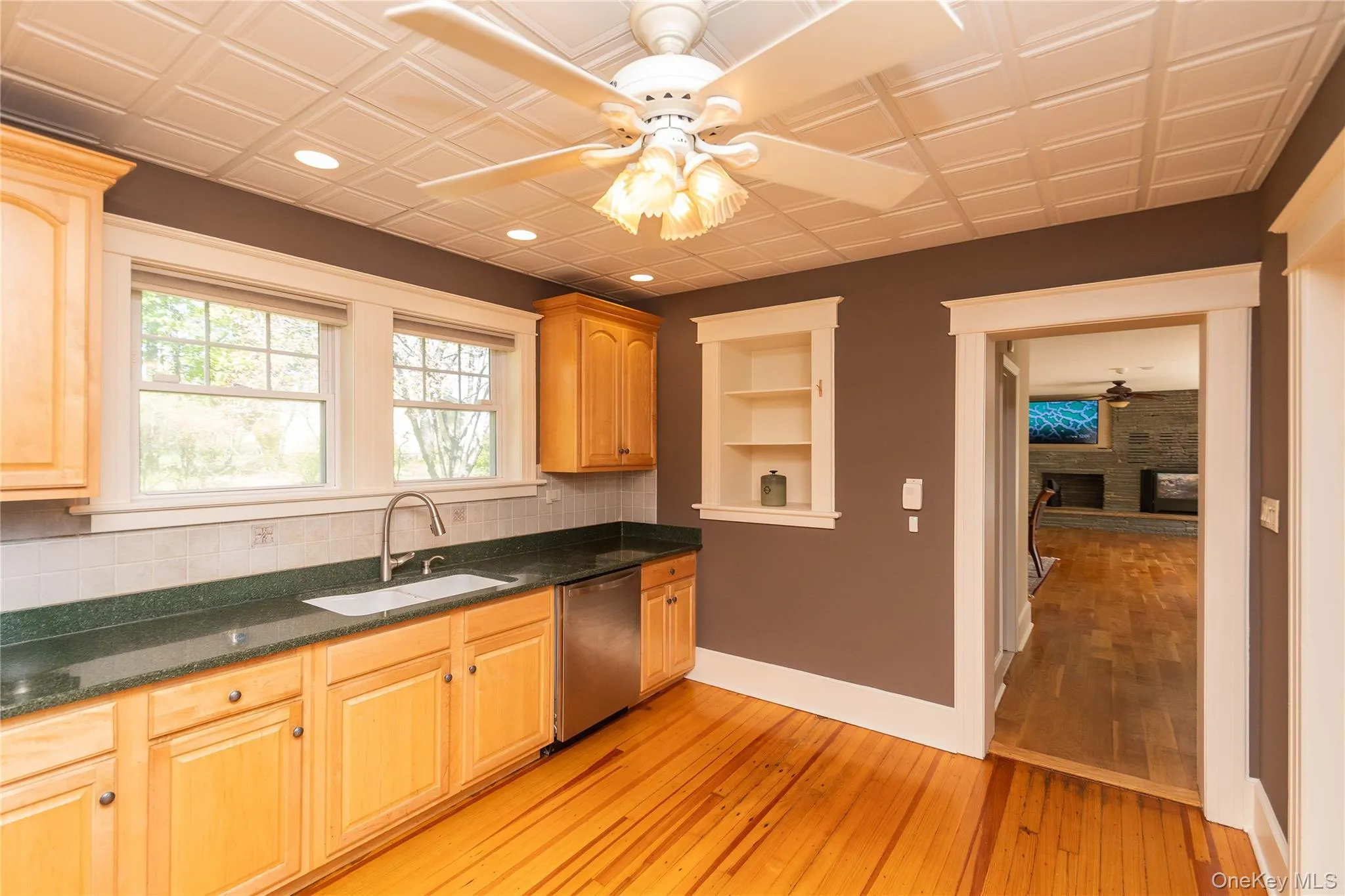 Washing dishes with a view. The windows keep the kitchen bright and airy Washing dishes with a view. The windows keep the kitchen bright and airy