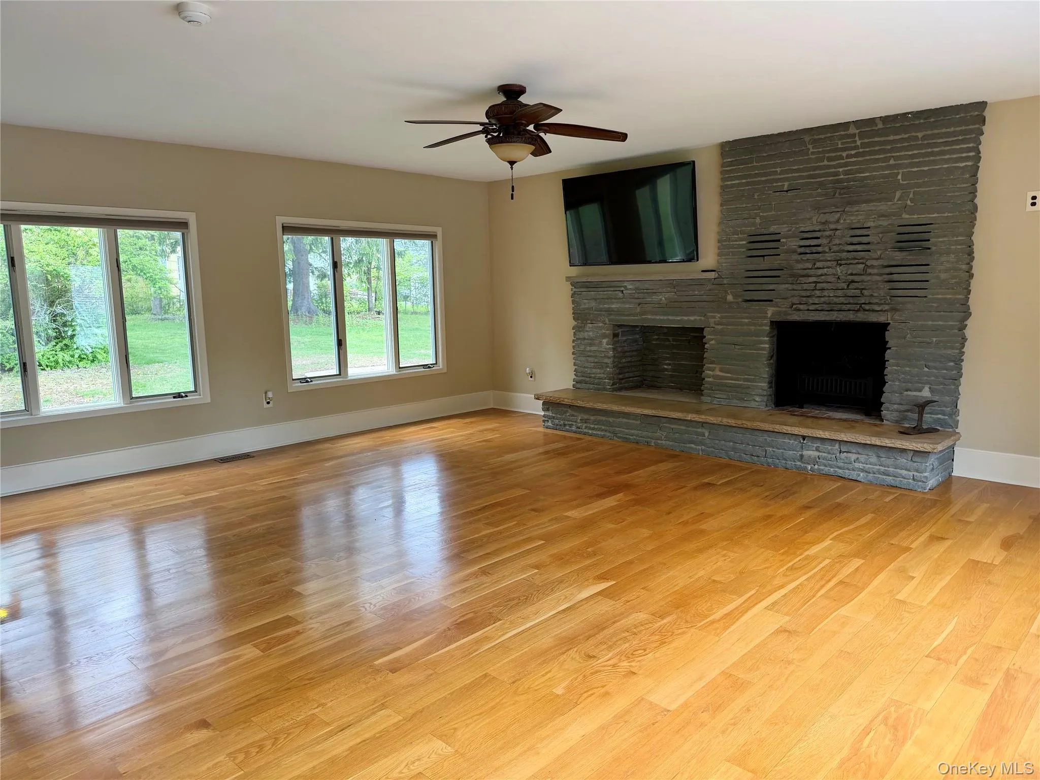Spacious family room with fireplace and built-in storage for wood. Spacious family room with fireplace and built-in storage for wood.