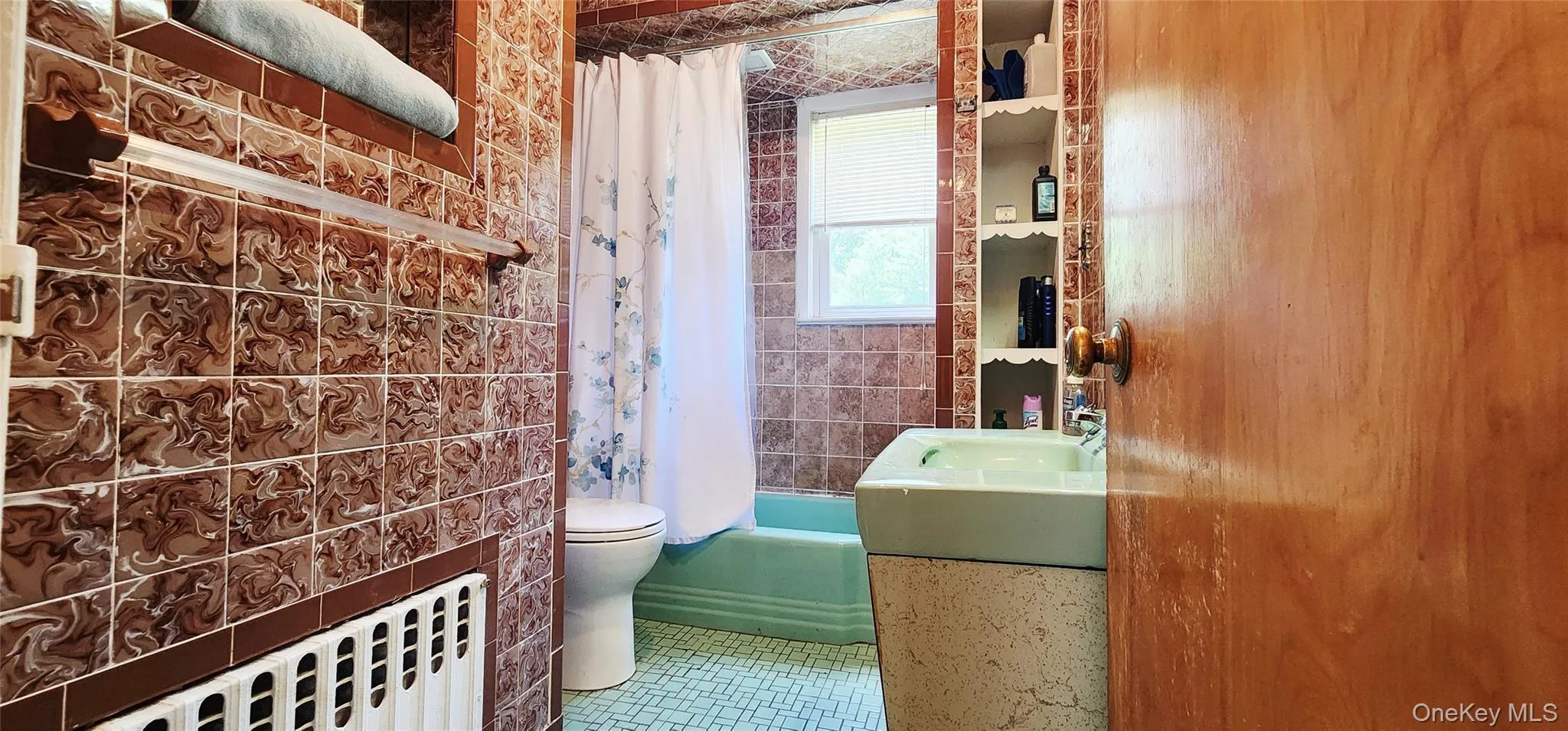 Full bathroom featuring radiator, tile patterned flooring, and vanity Full bathroom featuring radiator, tile patterned flooring, and vanity