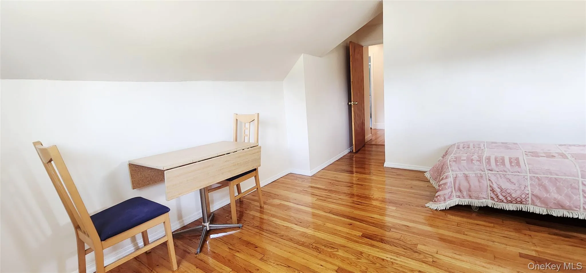 Bedroom featuring wood finished floors Bedroom featuring wood finished floors