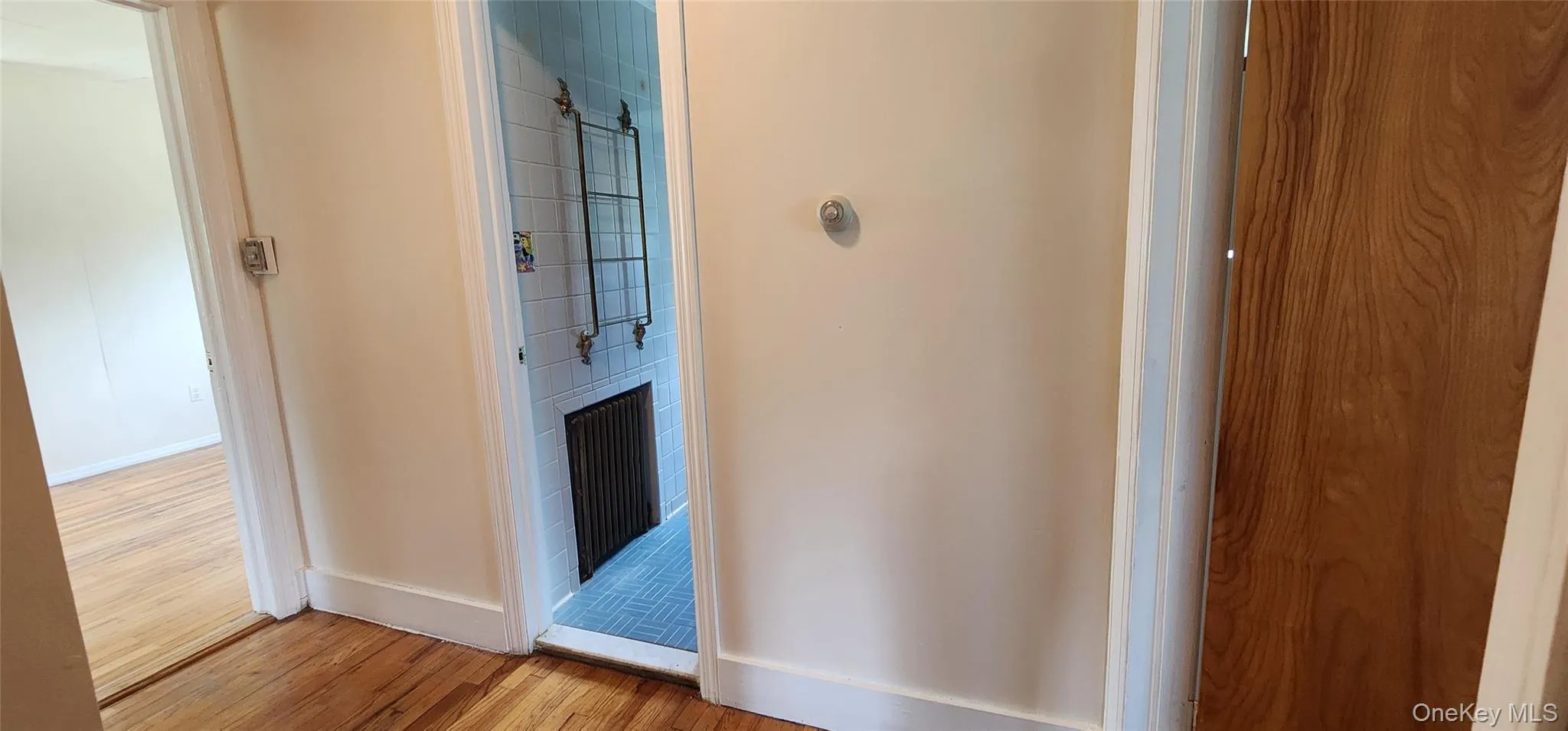 Hallway featuring light wood-type flooring and baseboards Hallway featuring light wood-type flooring and baseboards