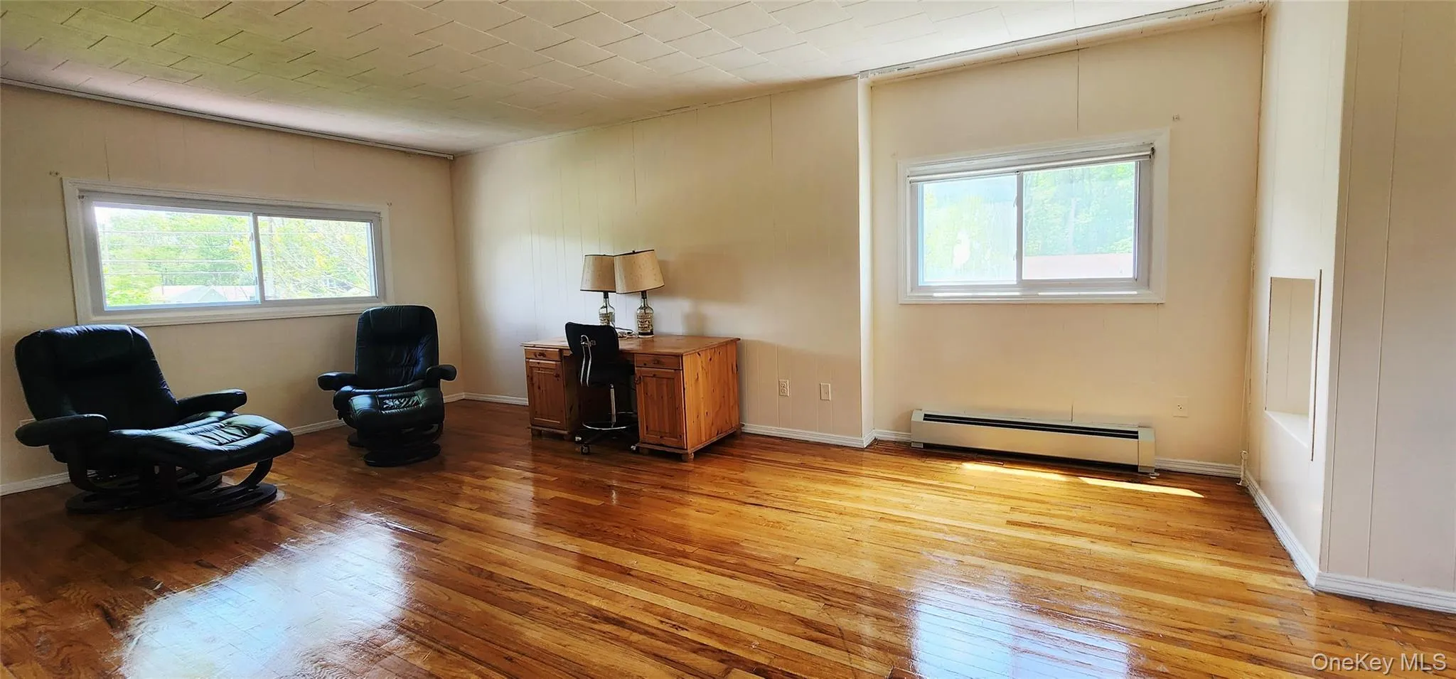 Sitting room featuring a baseboard heating unit and light wood-style floors Sitting room featuring a baseboard heating unit and light wood-style floors