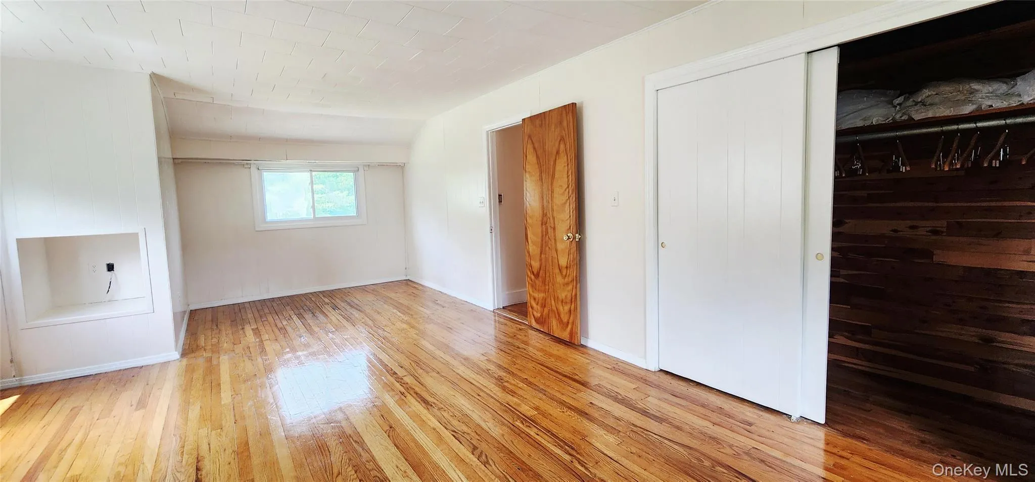 Unfurnished bedroom with light wood-style floors and a closet Unfurnished bedroom with light wood-style floors and a closet