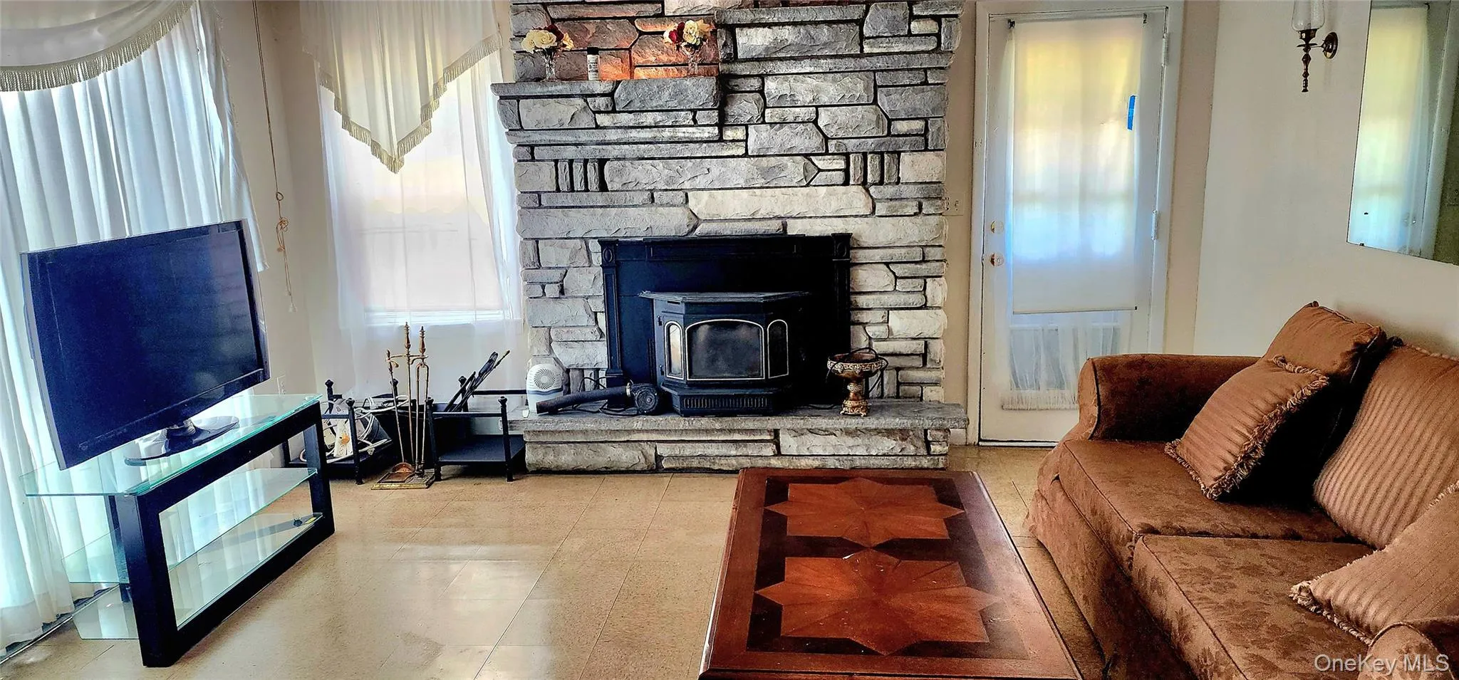 Living area featuring a wood stove Living area featuring a wood stove