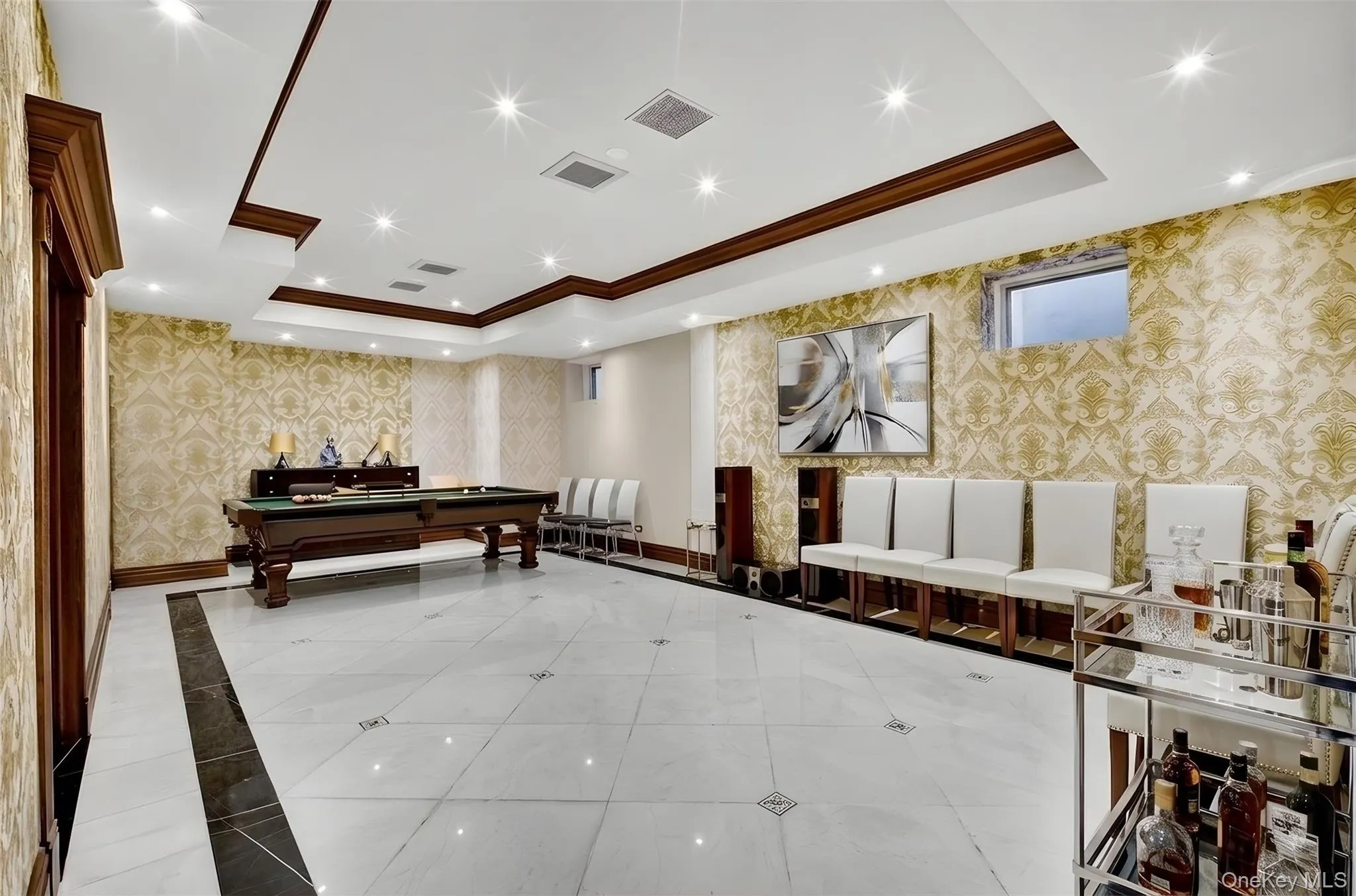 Common area featuring wallpapered walls, crown molding, a tray ceiling, and recessed lighting Common area featuring wallpapered walls, crown molding, a tray ceiling, and recessed lighting