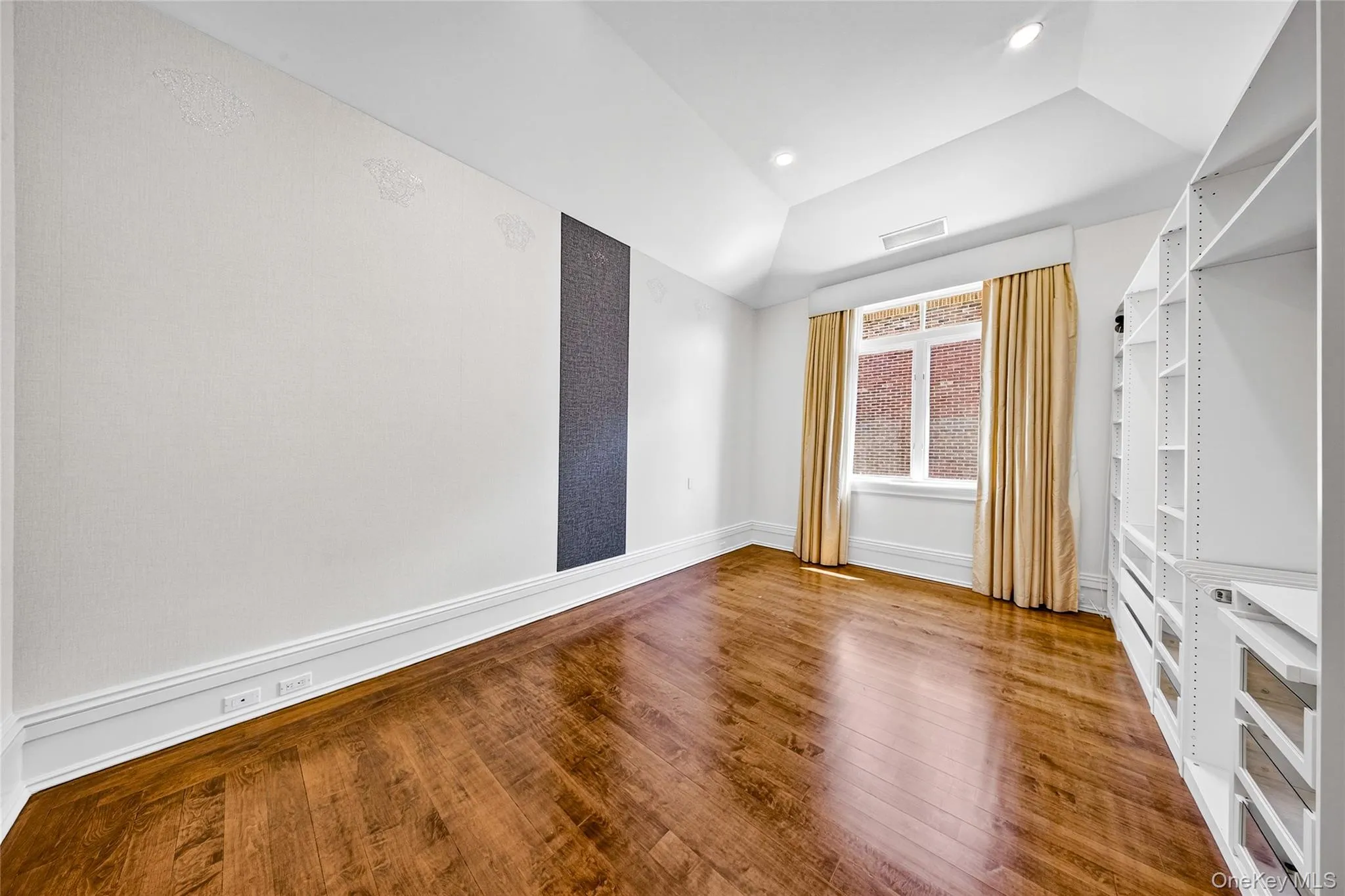 Empty room featuring lofted ceiling, hardwood / wood-style flooring, and recessed lighting Empty room featuring lofted ceiling, hardwood / wood-style flooring, and recessed lighting