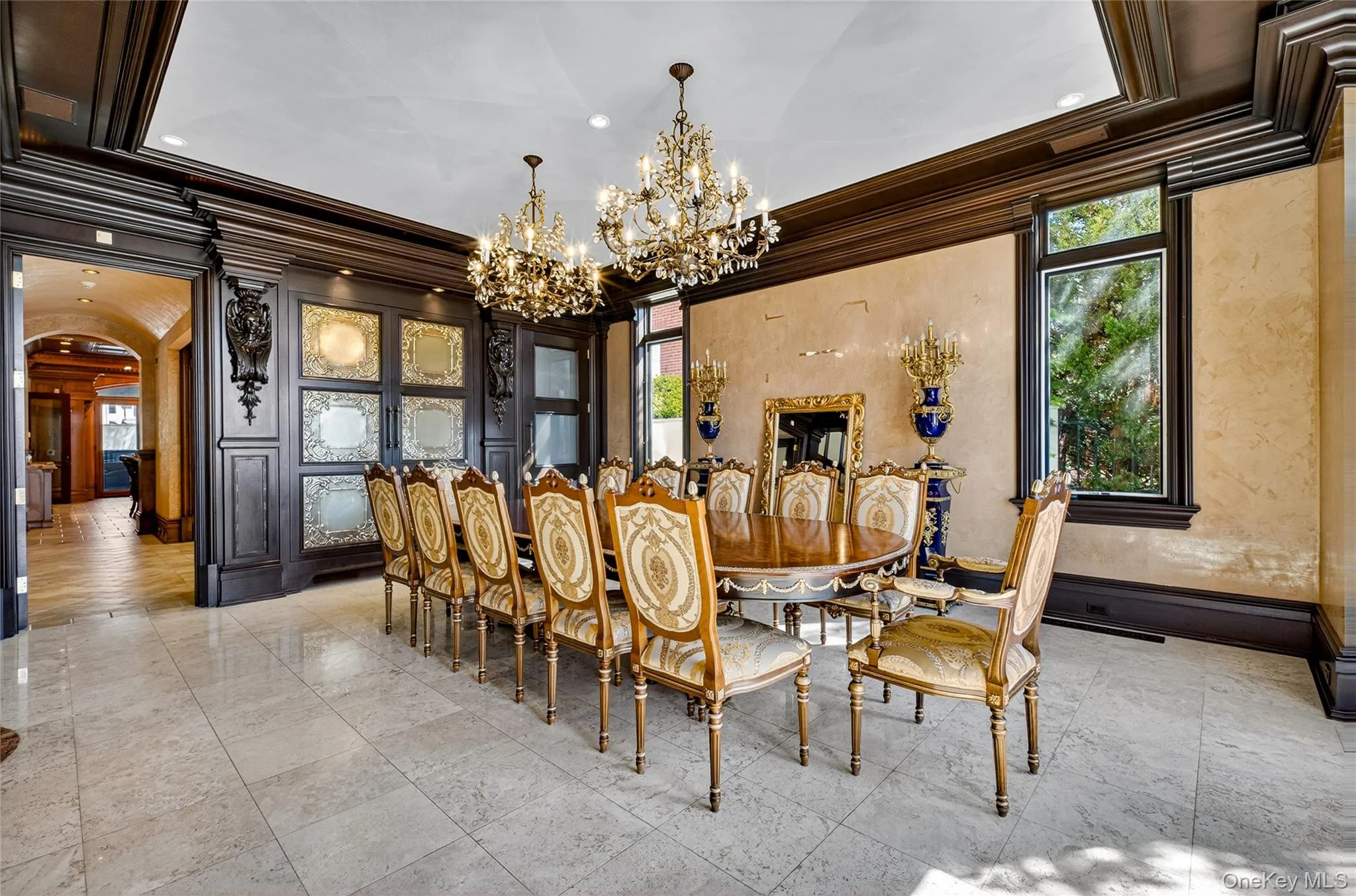 Dining space featuring arched walkways, suspended lighting, and ornamental molding Dining space featuring arched walkways, suspended lighting, and ornamental molding