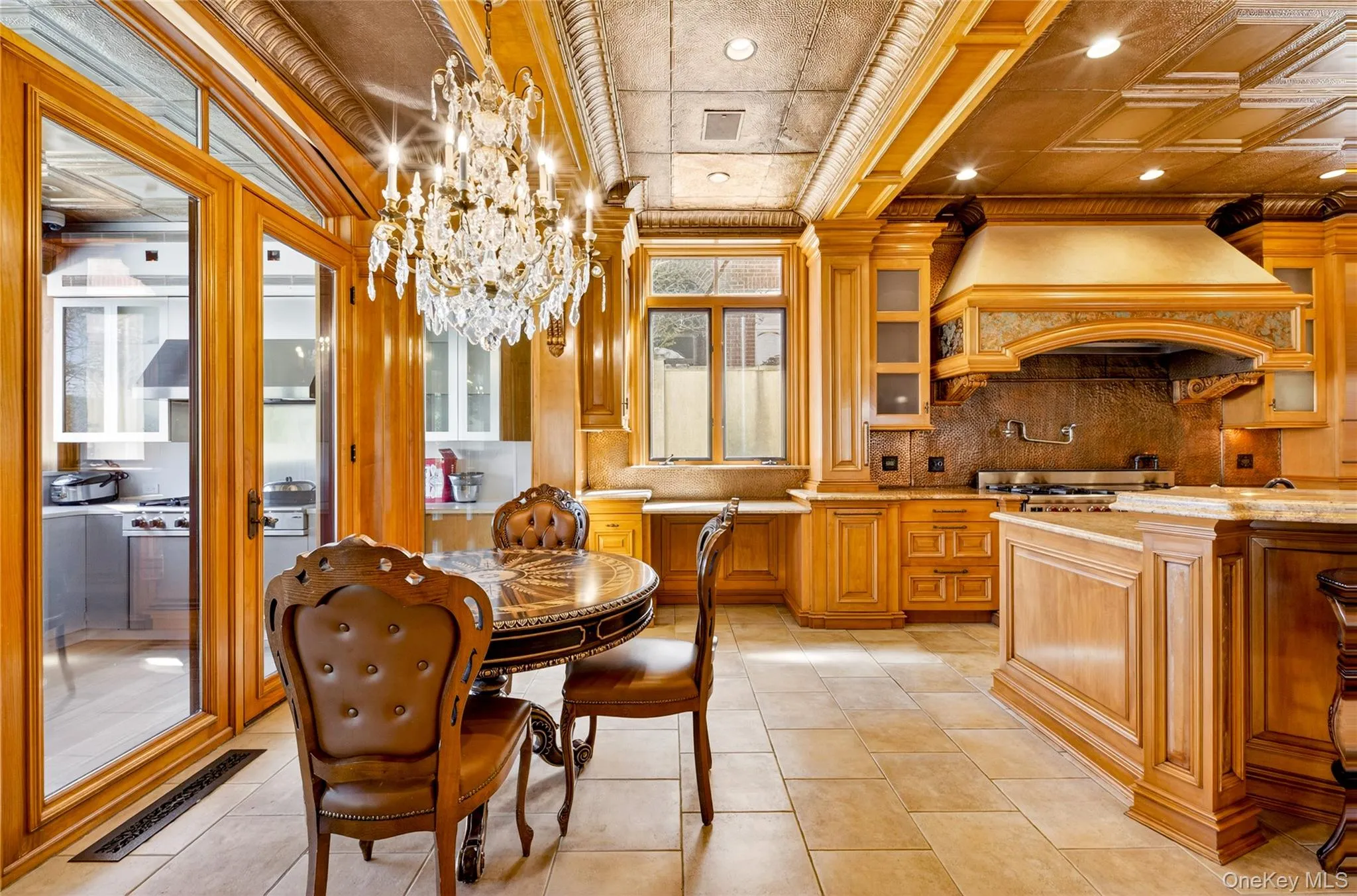 Dining space with hanging lights, an ornate ceiling, light tile patterned floors, and crown molding Dining space with hanging lights, an ornate ceiling, light tile patterned floors, and crown molding